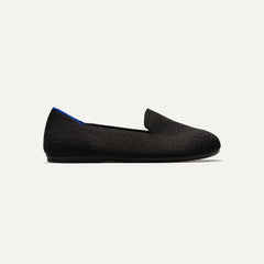 side | The Kids slip-on Loafer in Black Solid shown from a side view showing the outsole.