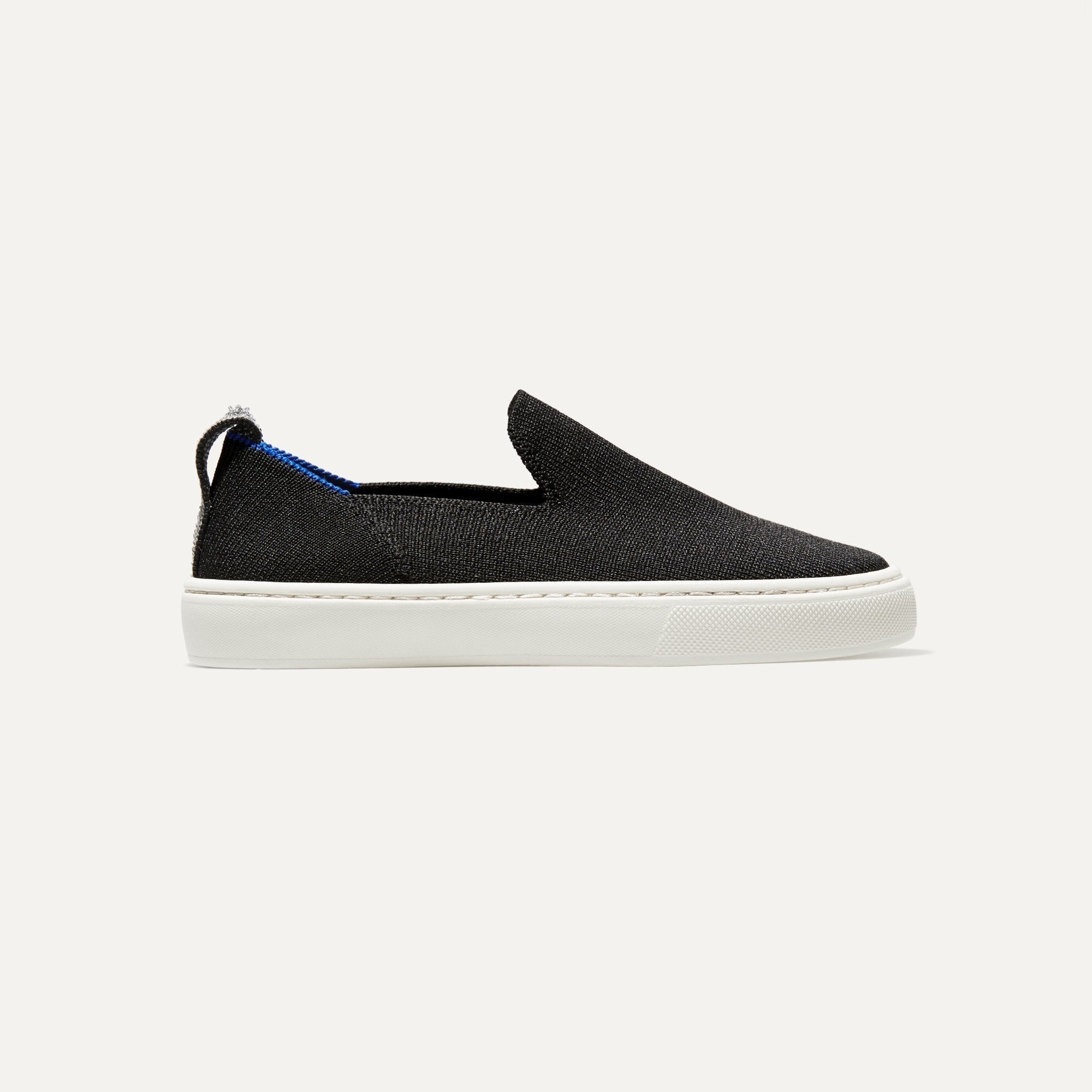 side | The Kids slip-on Sneaker in Black shown from a side view showing the outsole.