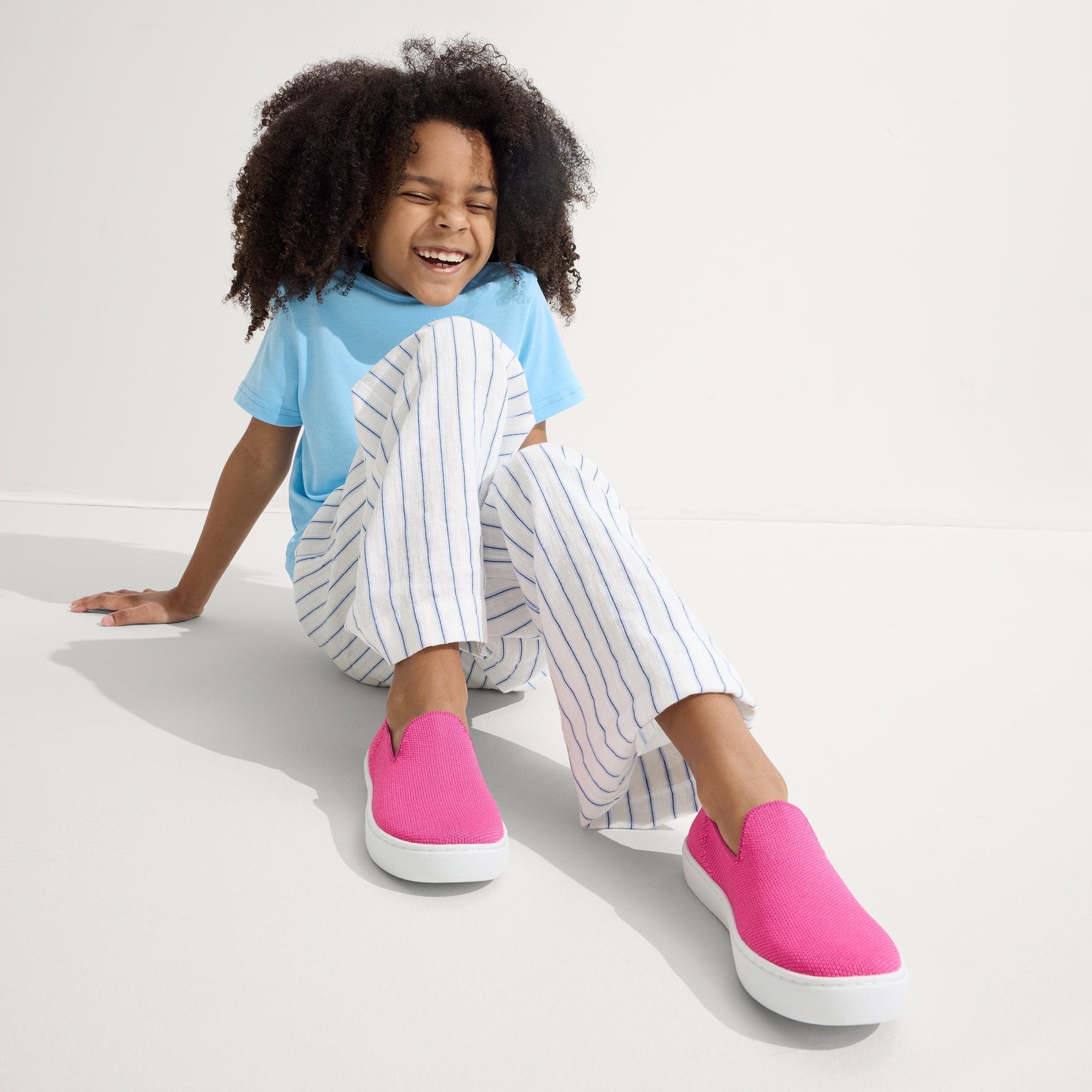 model | Alternate view of a model wearing The Kids Sneaker in Bubblegum.