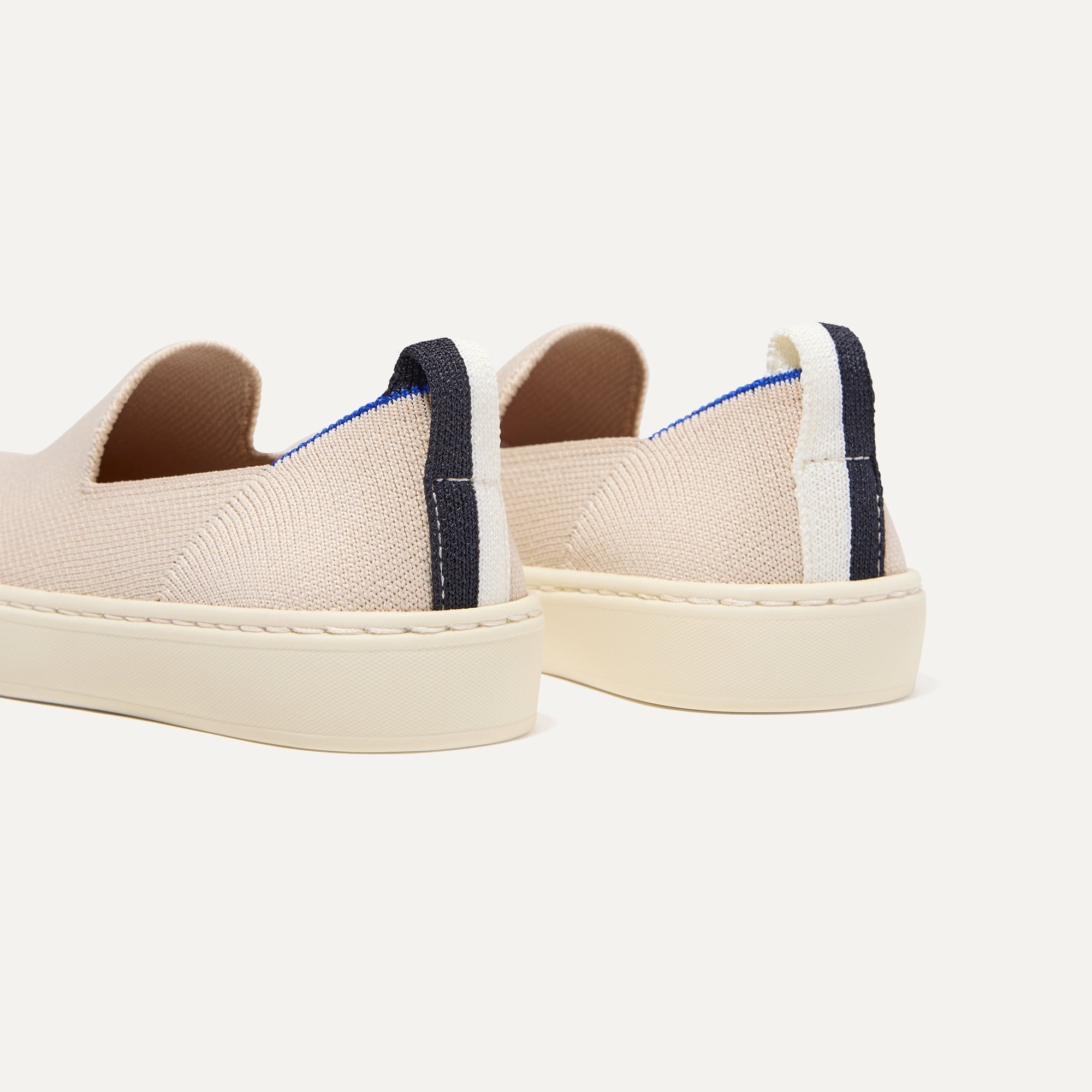 Close up of the heel of The Kids Sneaker in Sand, with shimmery gold pull tab.