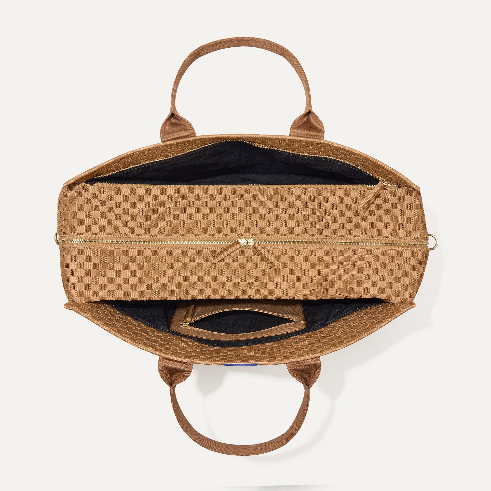 The Weekender in Hazelnut shown from the top with zipper side compartment and magnetic side compartment open. 