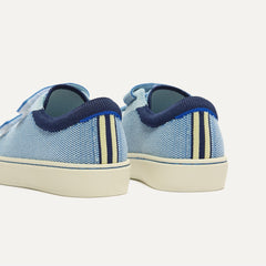 Close up of the heel of The Kids Strap Sneaker in Berry Blue, with Rothy's signature blue halo. 