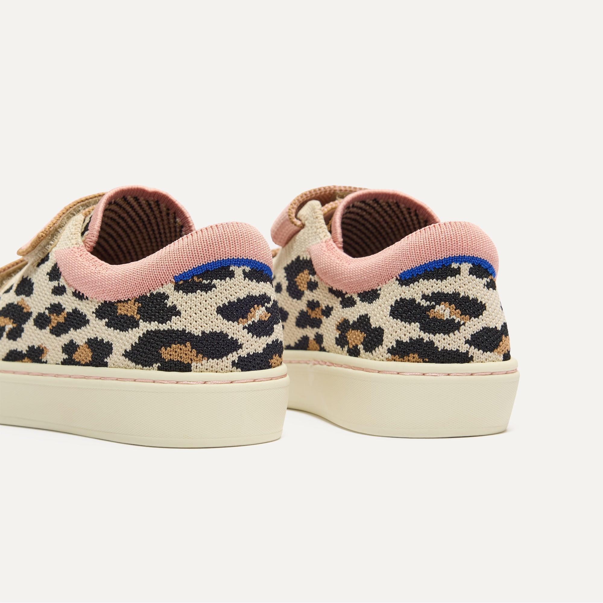 Close up of the heel of The Kids Strap Sneaker in Cat Blush, with Rothy's signature blue halo. 