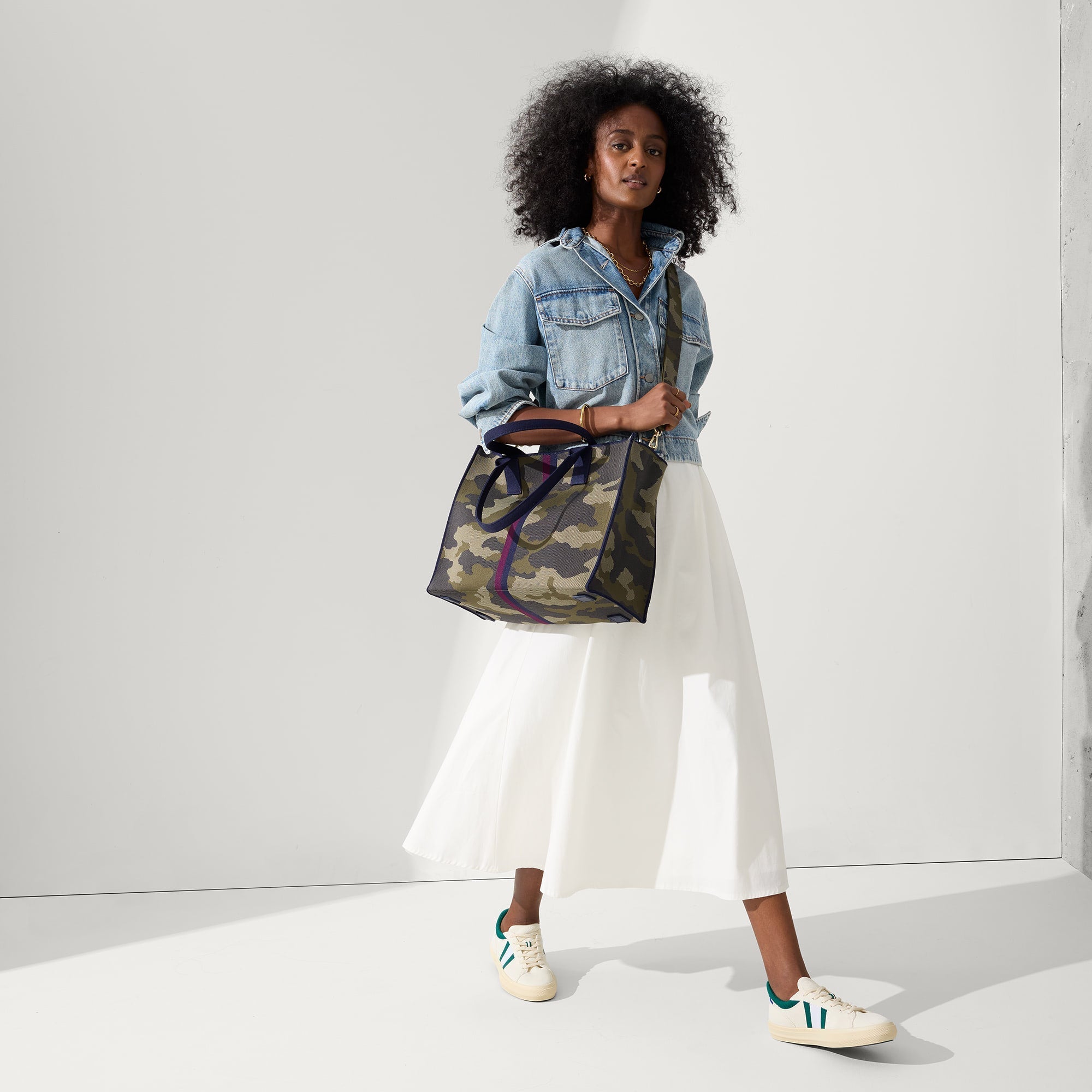 model | Overlay:: Shown with The Crossbody Strap (sold separately). | Alt:: Alternate view of a model wearing The RS02 Sneaker in Kelly.