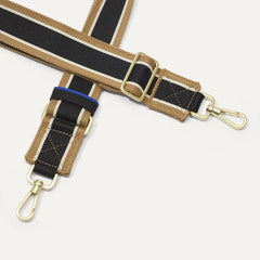 A close-up of The Crossbody Strap in Khaki Stripe, focusing on the end snap hooks and sliding buckle.