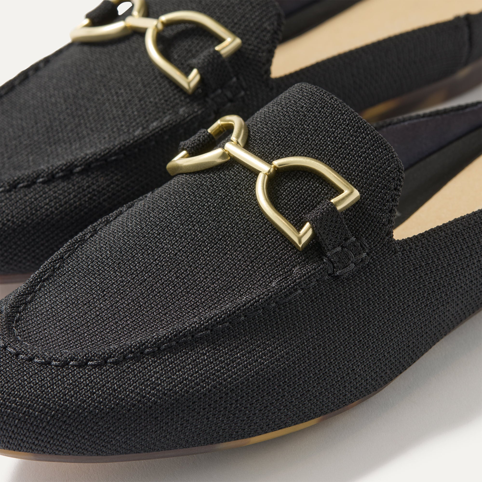 Close up of the toe and hardware of The Double Bit Loafer Mule in Black. 