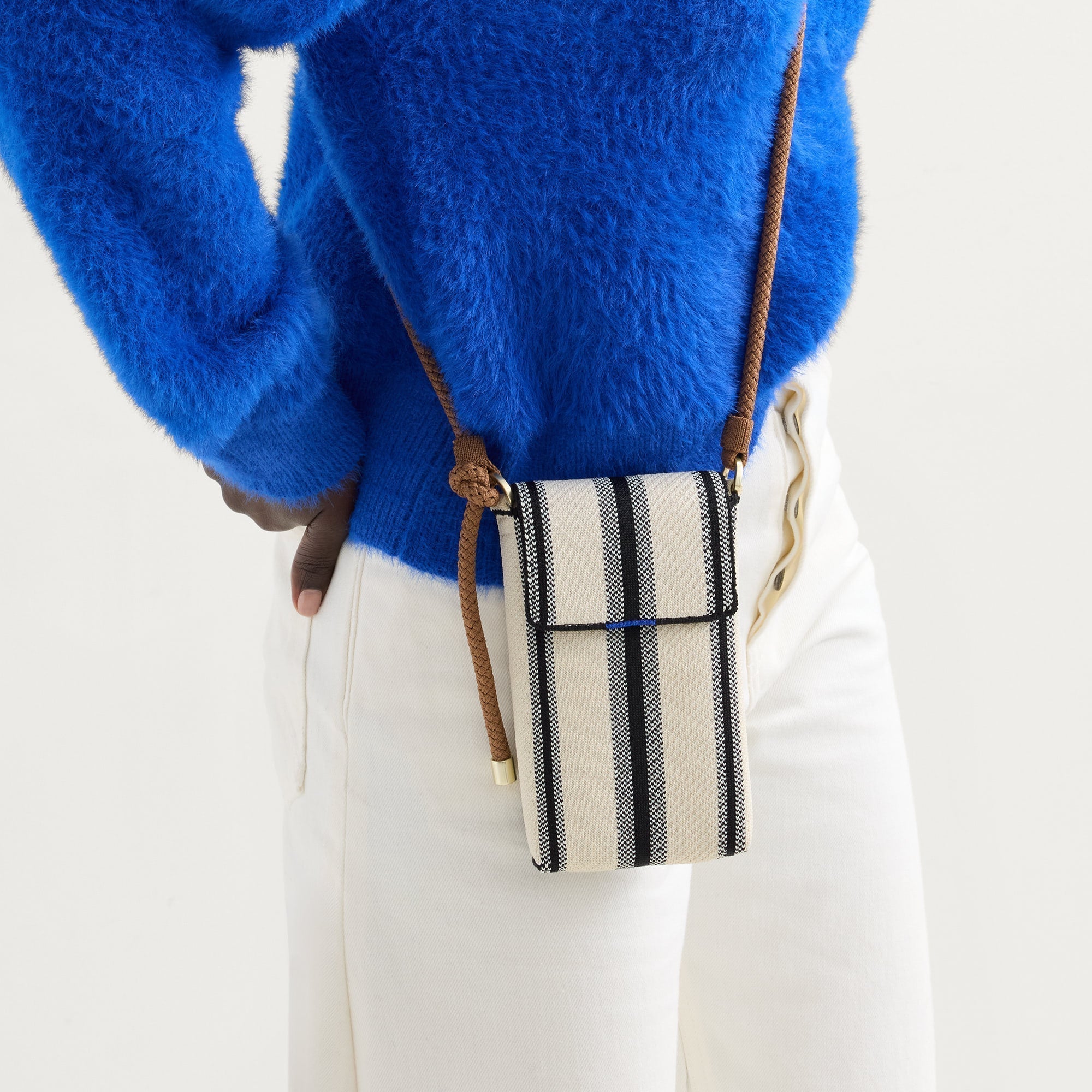 hover | An alternate view of a model wearing The Phone Crossbody in Coastline.