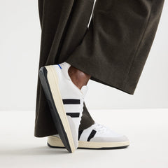 hover | Model wearing The Men's Court Sneaker in Black Drift.