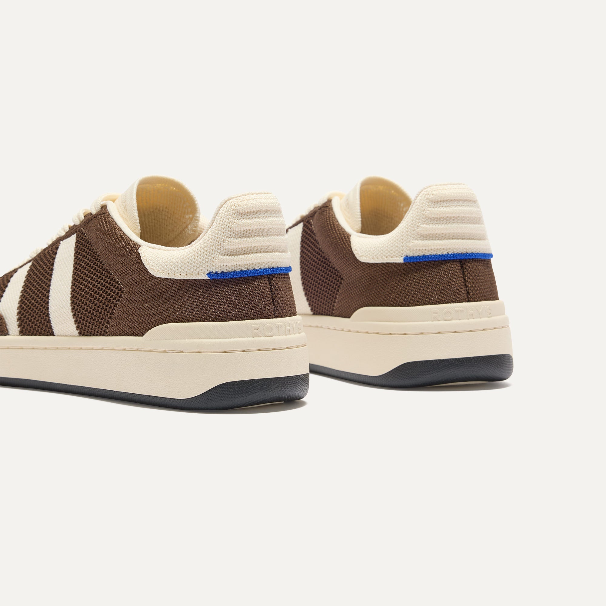 Close up of the heel of The Men's Court Sneaker in Dugout, with Rothy's signature blue halo. 