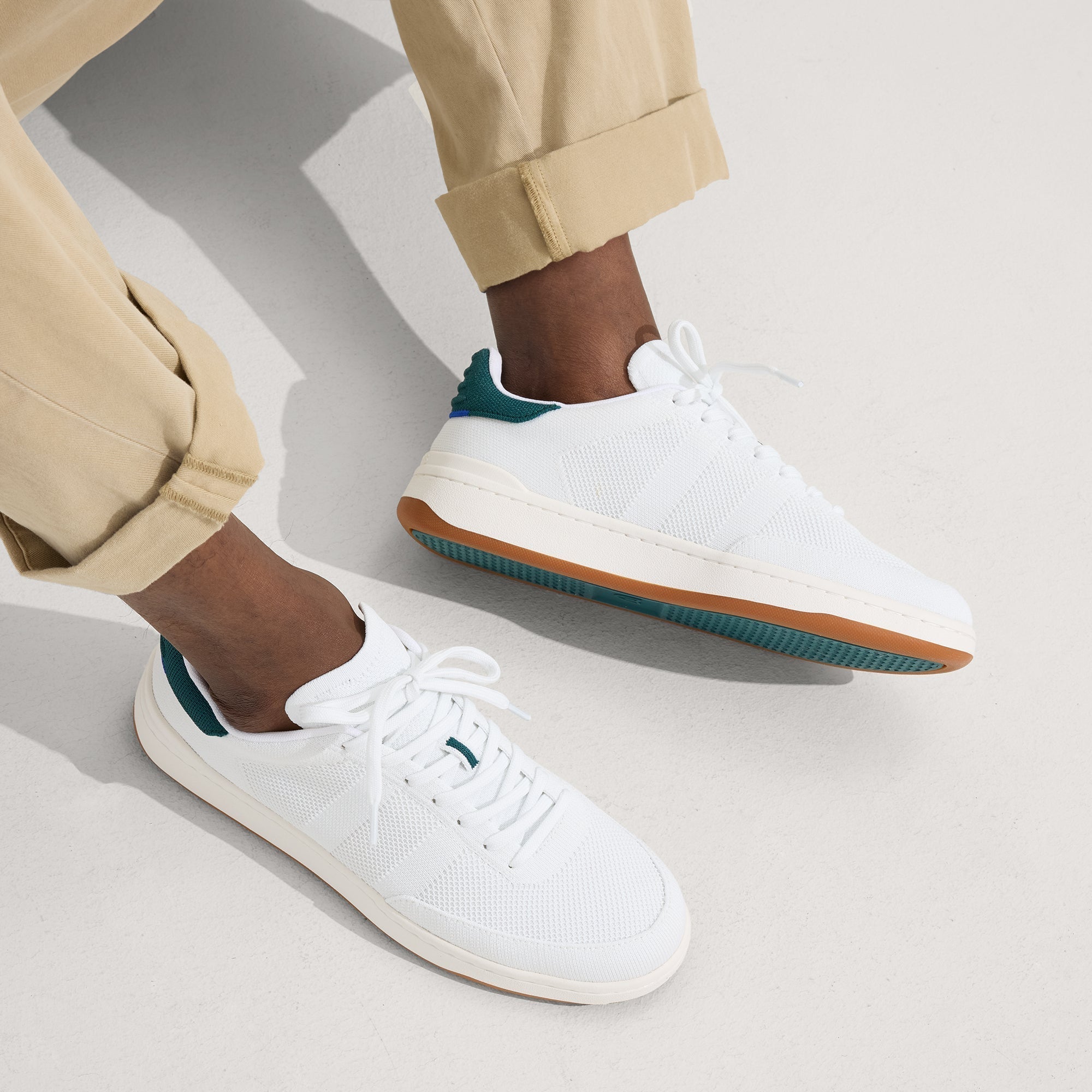 hover | Model wearing The Men's Court Sneaker in Turf. 