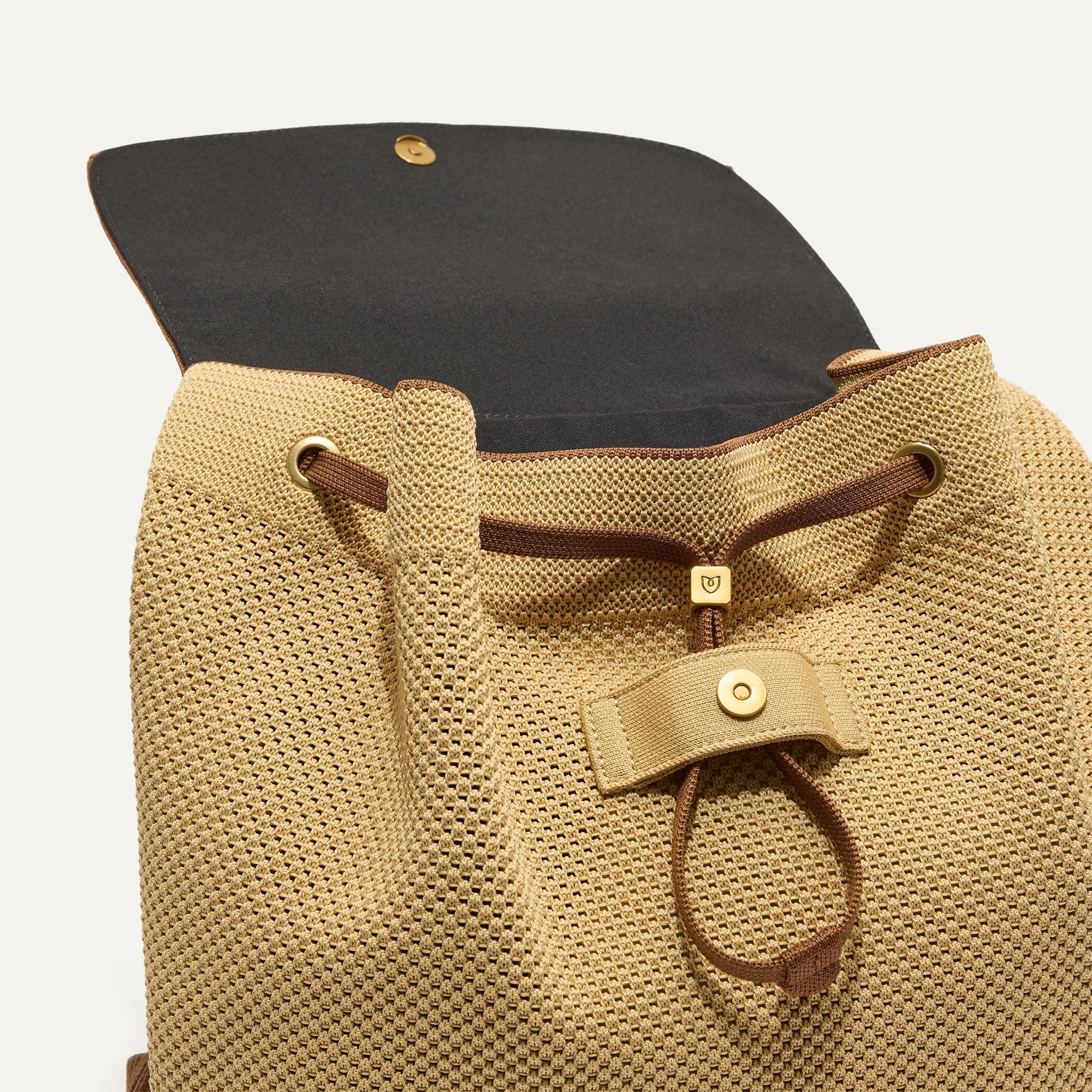 A close up of The Cinch Backpack in Brown Butter showing the drawstring closure.