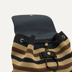 A close up of The Cinch Backpack in Mocha Stripe Crochet showing the drawstring closure.