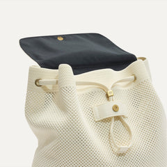 A close up of The Cinch Backpack in Coconut Crochet showing the drawstring closure.