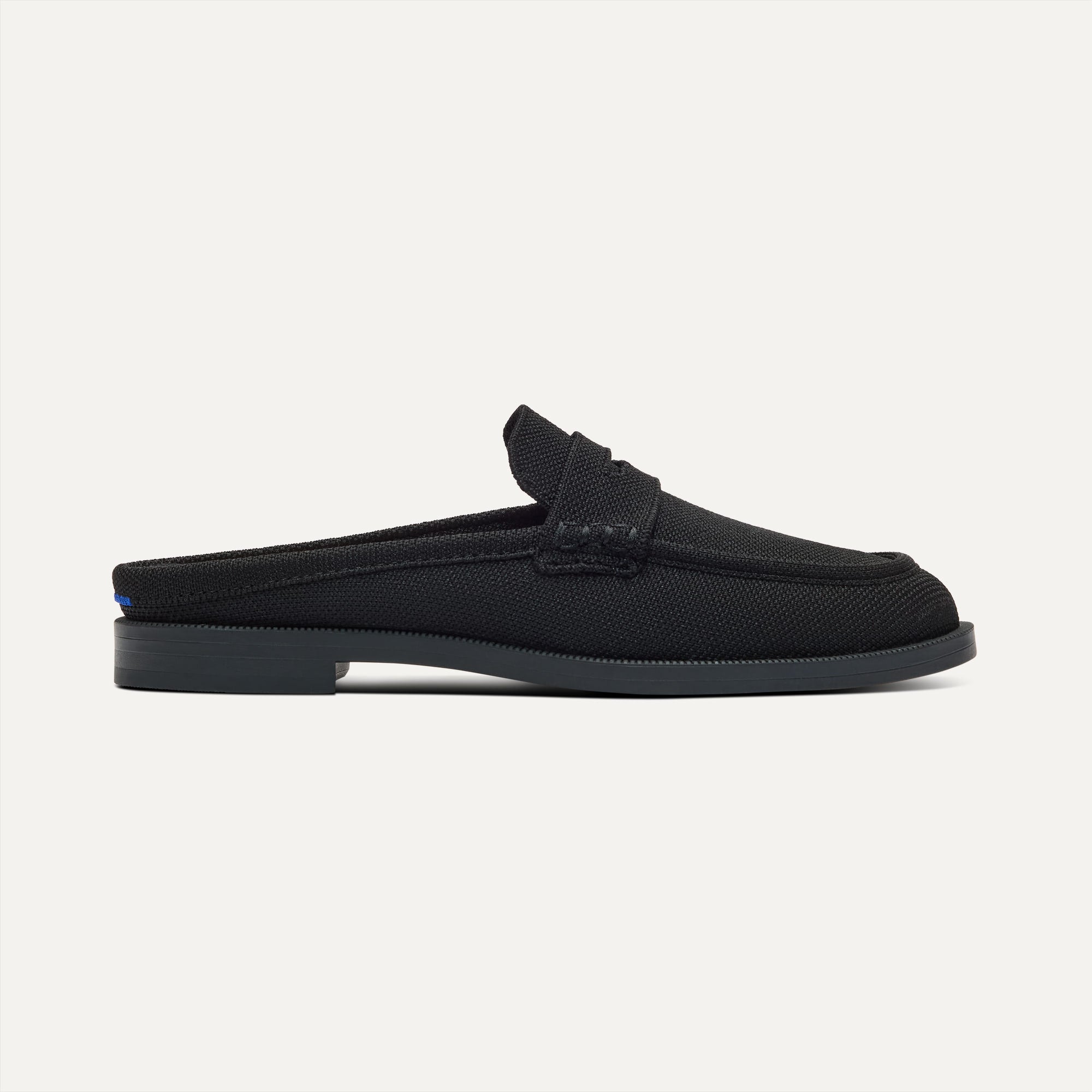 side | The Penny Loafer Mule in Black shown from the side.