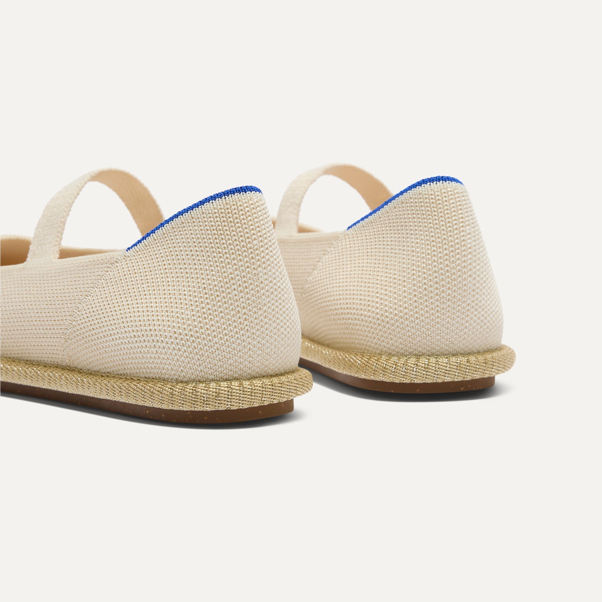 Close up of the heel of The Cruiser Mary Jane in White Sand, with Rothy's signature blue halo. 