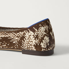 Close up of the heel of The Point III in ReVelvet Brown Python, with Rothy's signature blue halo. 