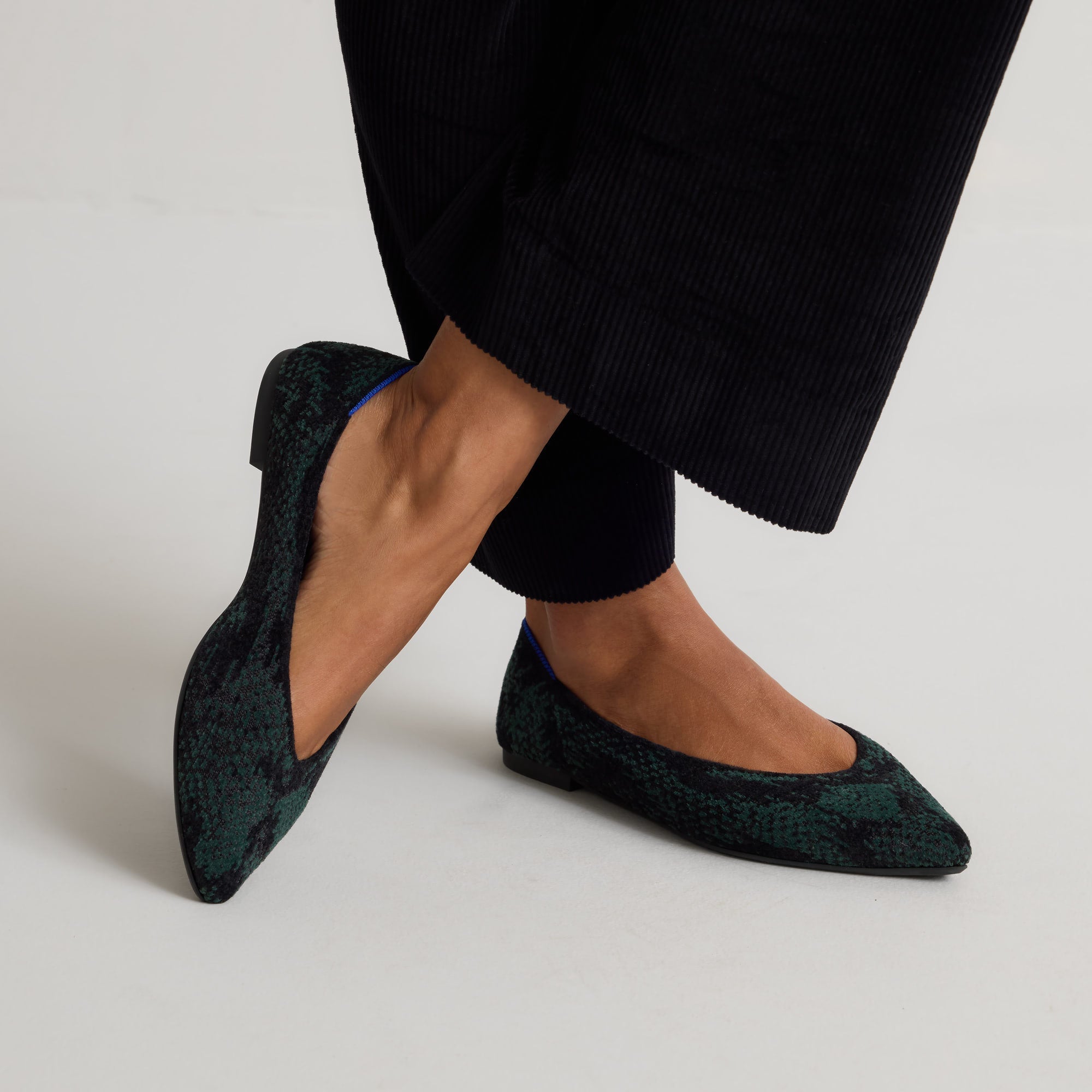 hover | Model wearing The Point III in ReVelvet Evergreen Python. 