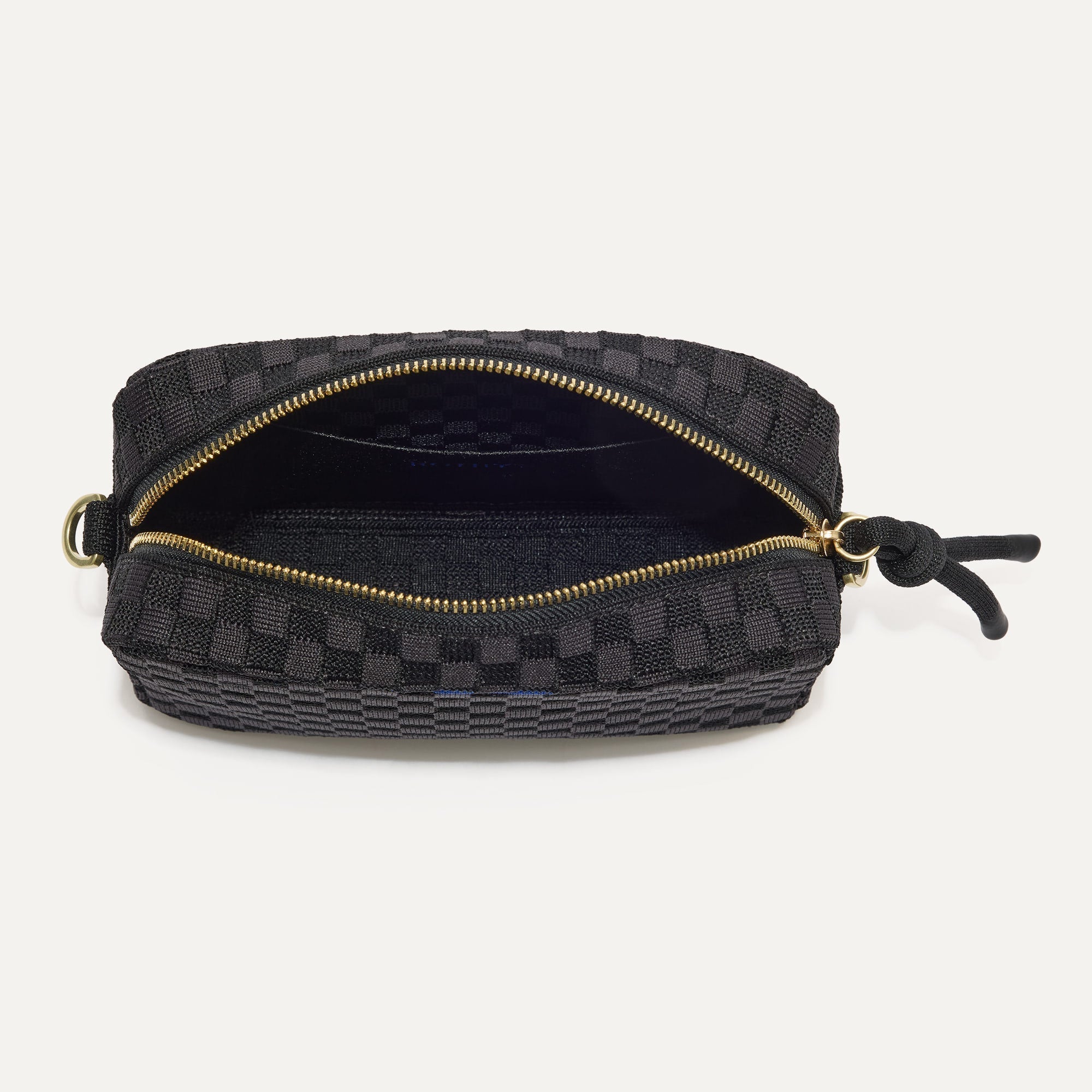 The Crossbody Camera Bag in Black Sand, shown from above, with the interior exposed.