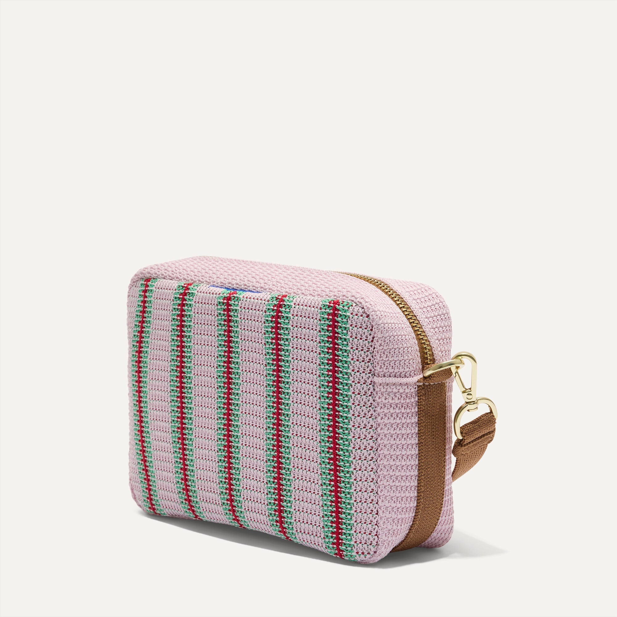 The Crossbody Camera Bag in  Watermelon Market Stripe, shown from the side. 