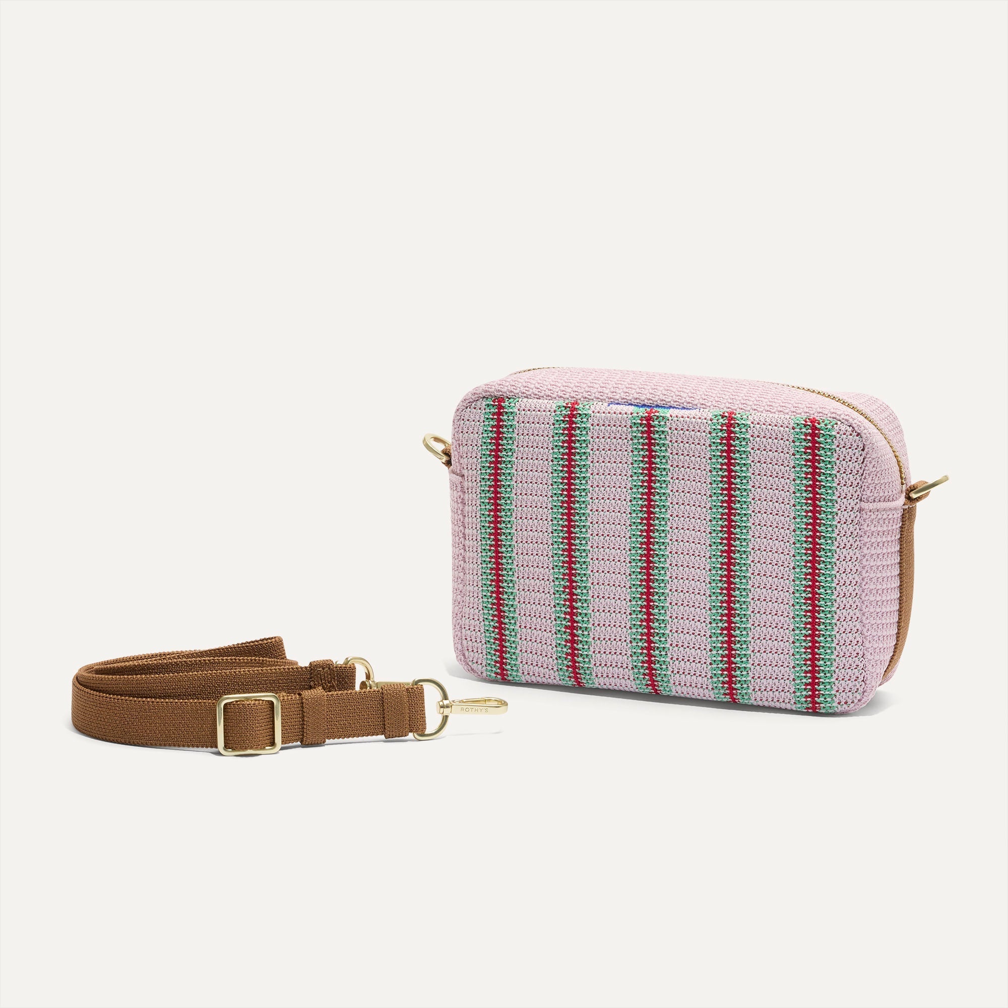 The Crossbody Camera Bag in Watermelon Market Stripe shown by itself with removable strap. 