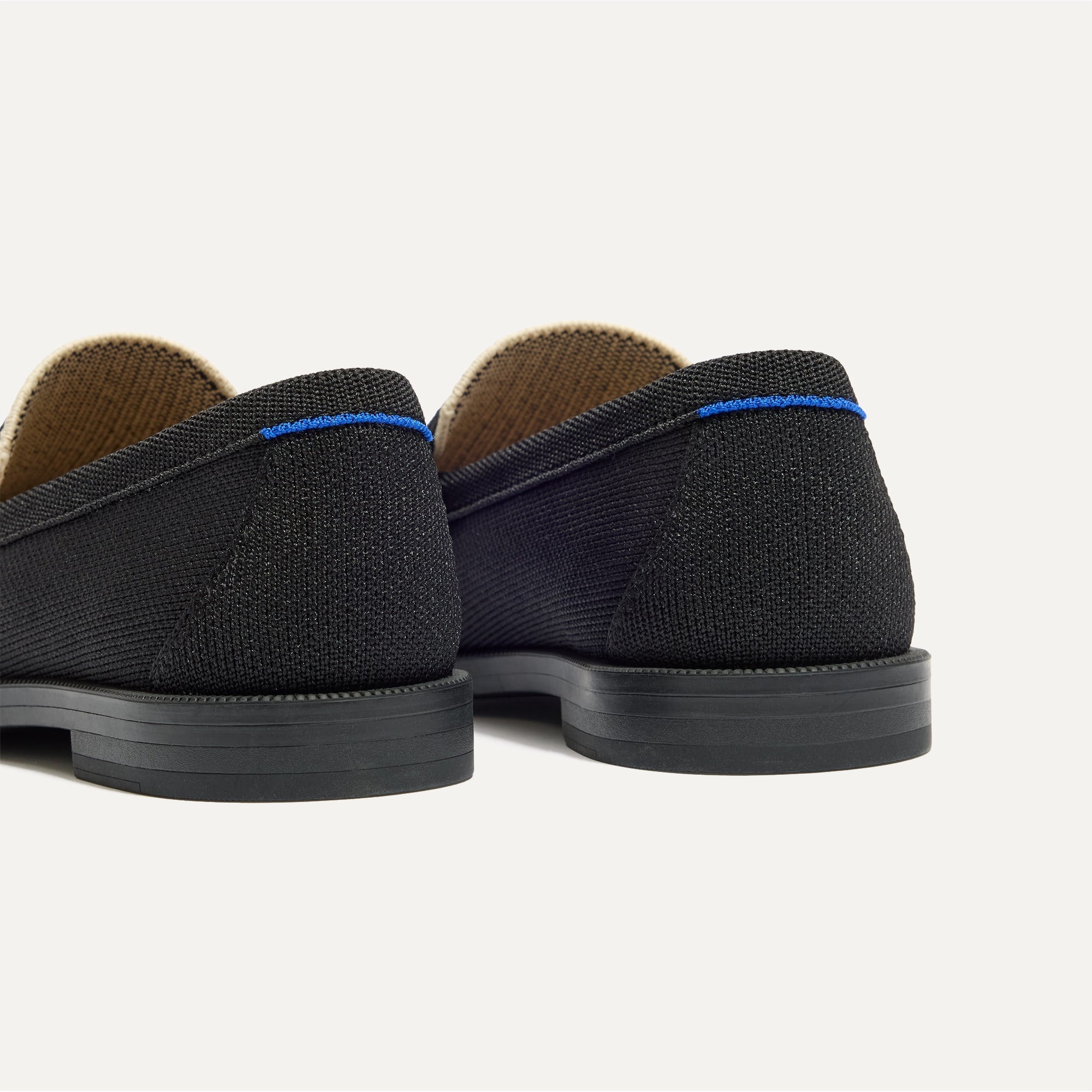 Close up of the heel of The Penny Loafer in Tuxe, with Rothy's signature blue halo. 
