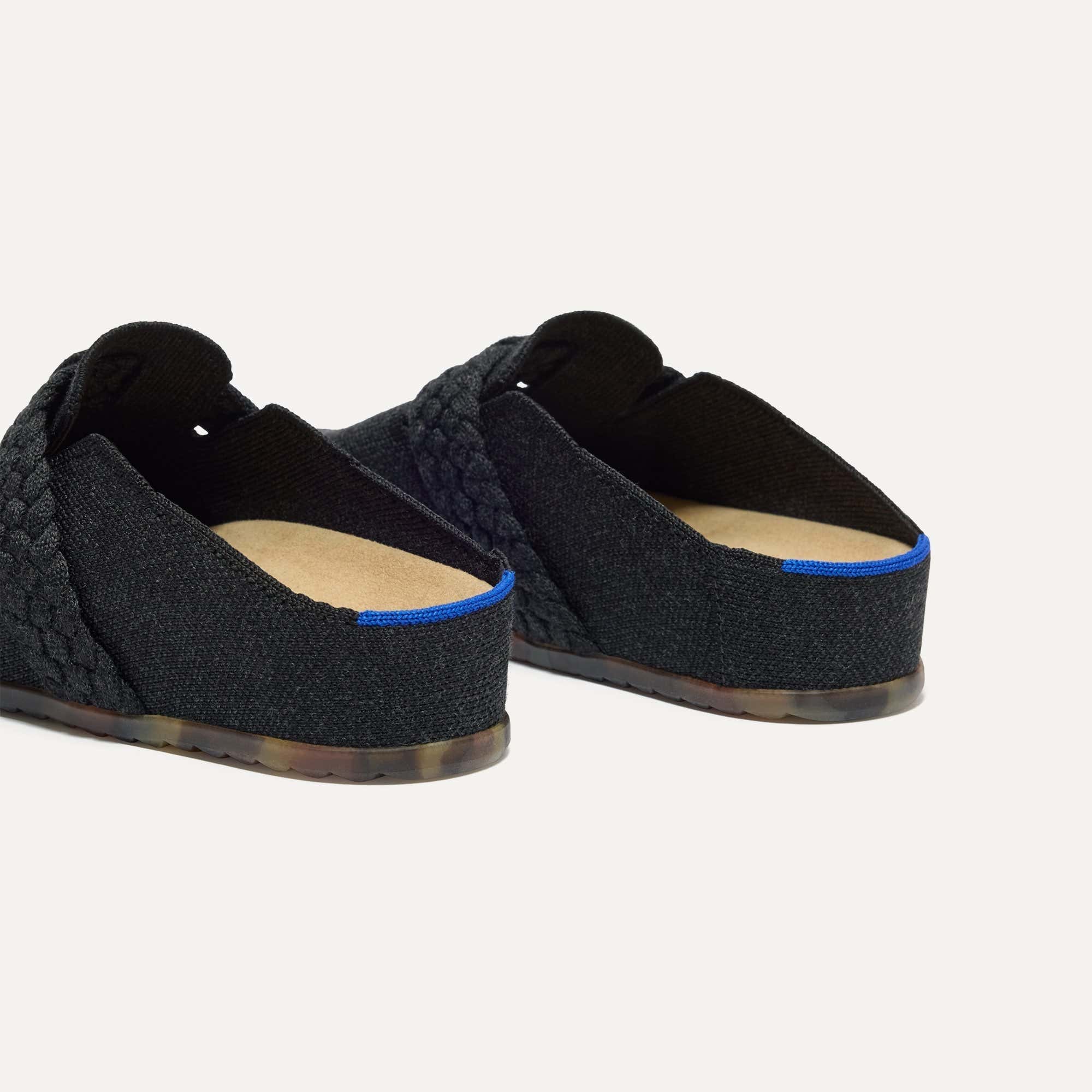 Close up of the heel of The Braid Clog in Black, with Rothy's signature blue halo. 