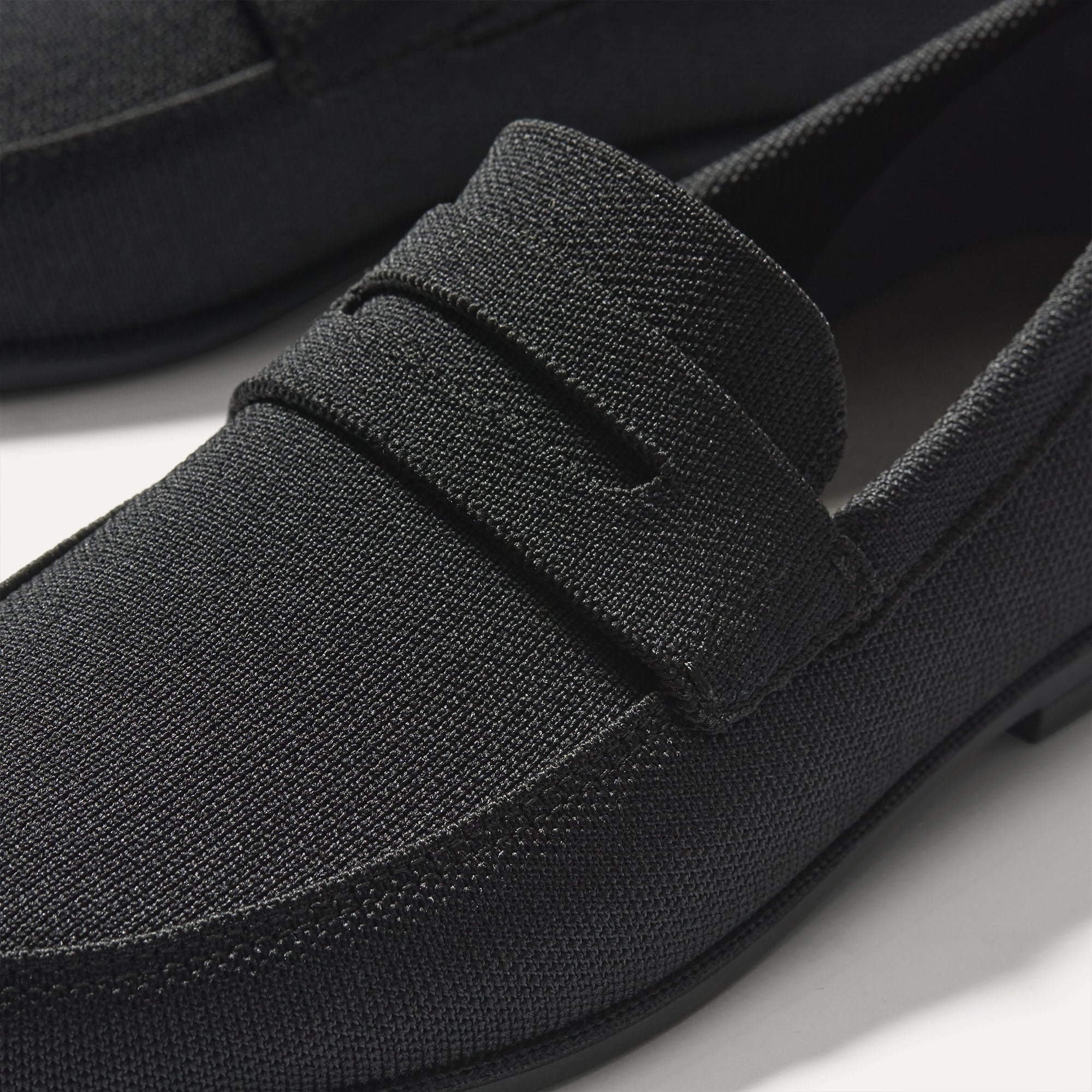 Close up of the vamp and penny keeper detail on The Ravello Penny Loafer in Black.