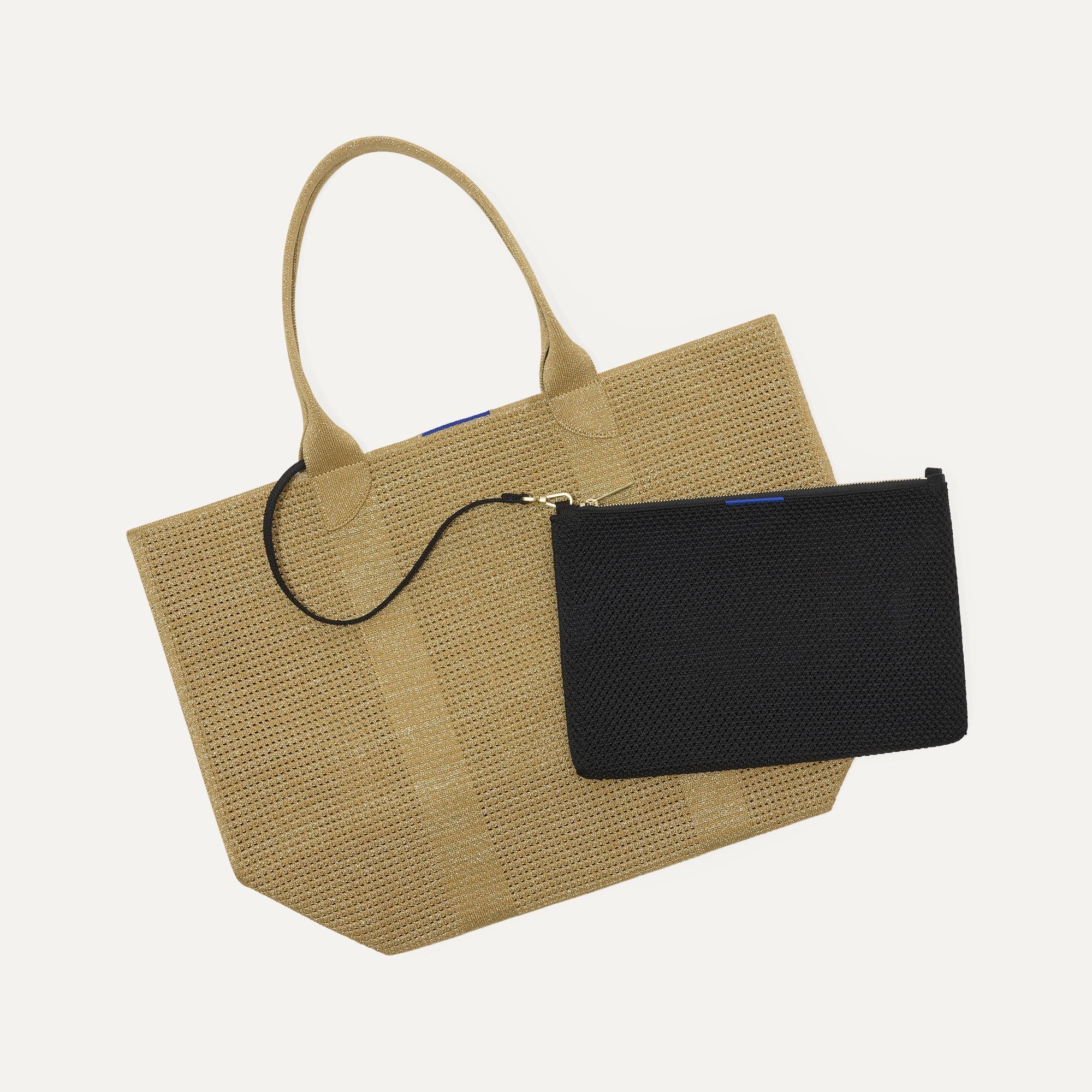 Overlay:: Clips onto The Lightweight Tote key leash. | Alt:: An image of The Convertible Clutch in Black Espresso Open Knit clipped to The Lightweight Tote key leash.
