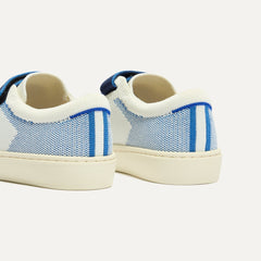 Close up of the heel of The Kids Strap Sneaker in Blue Raspberry, with Rothy's signature blue halo. 