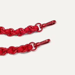 A close-up of The Crossbody Strap in Scarlet Chain-Knit, focusing on the end snap hooks.