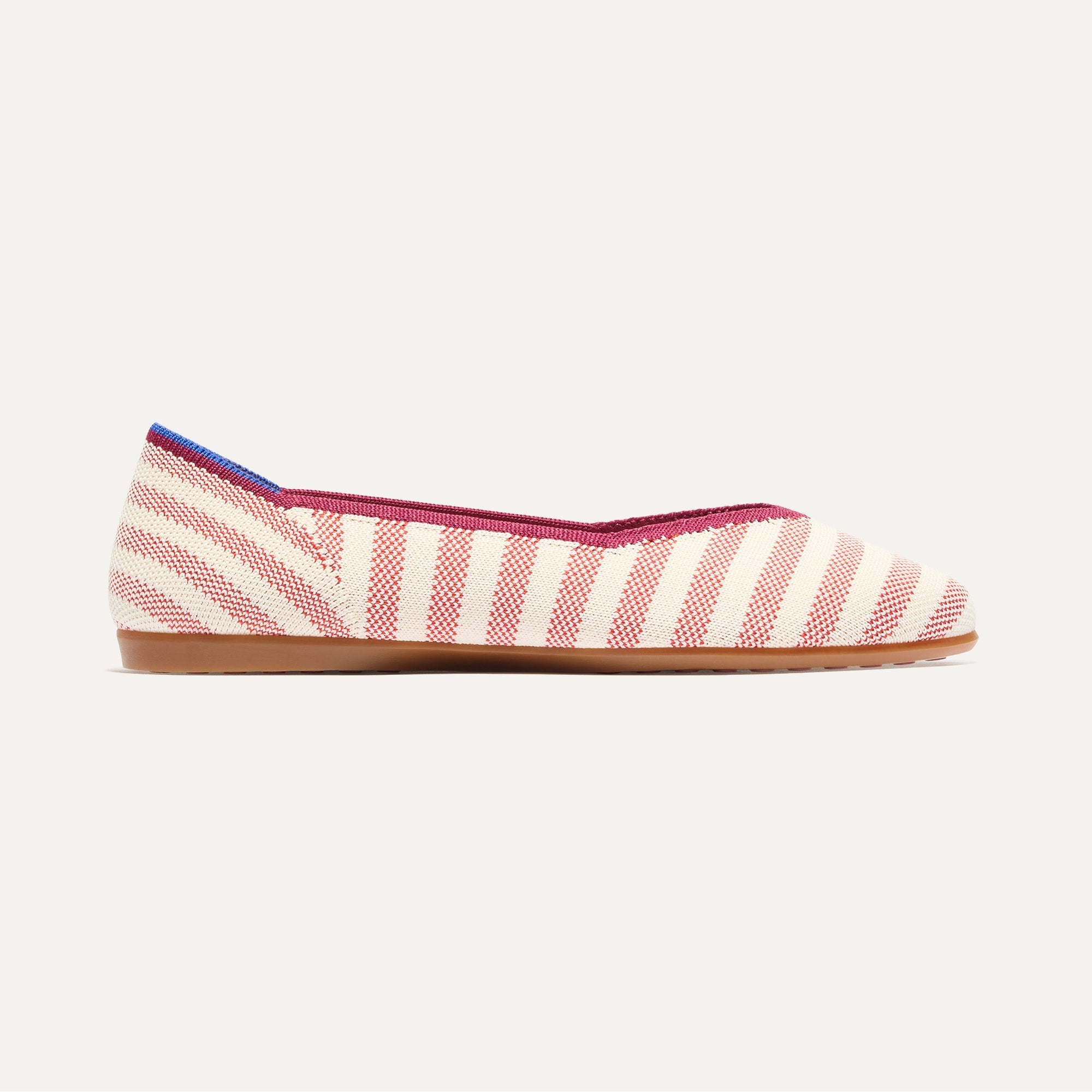 side | The Daily Flat in Coral Cabana Stripe shown from the side. 