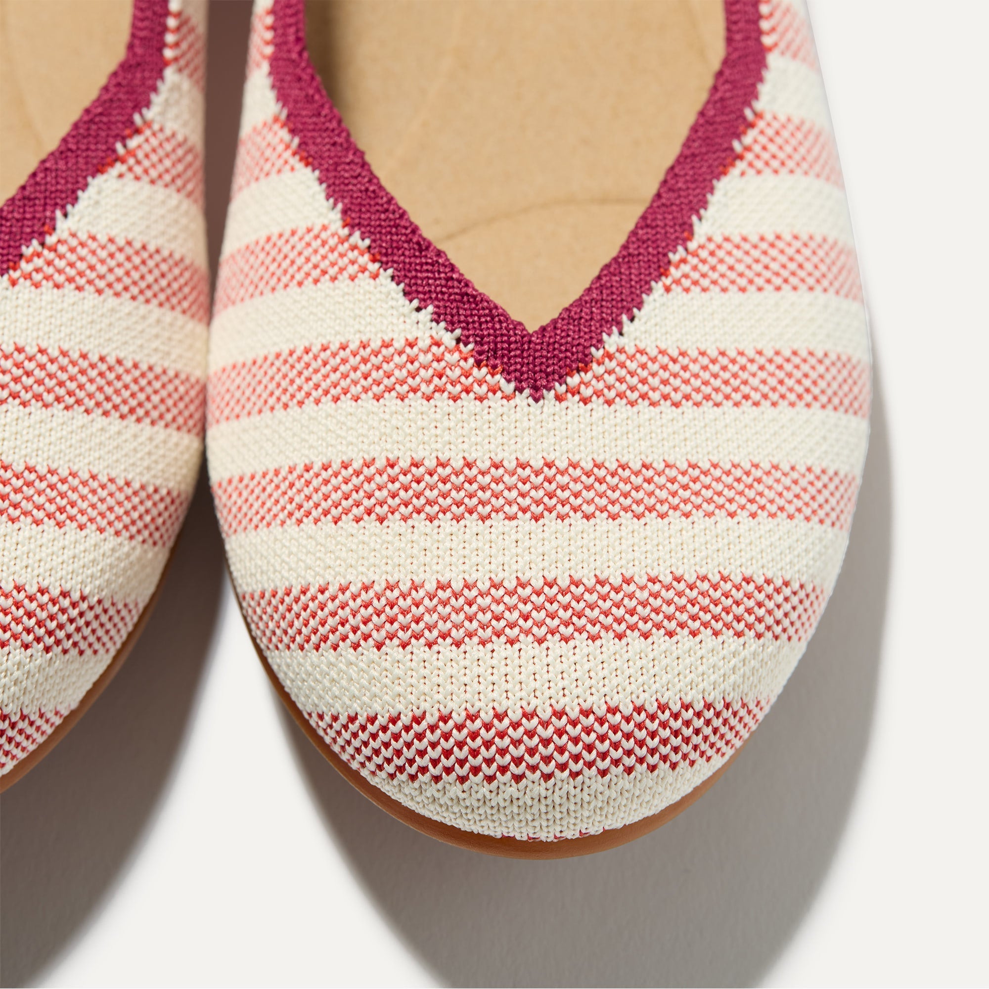 Close up of the toe and vamp of The Daily Flat in Coral Cabana Stripe. 