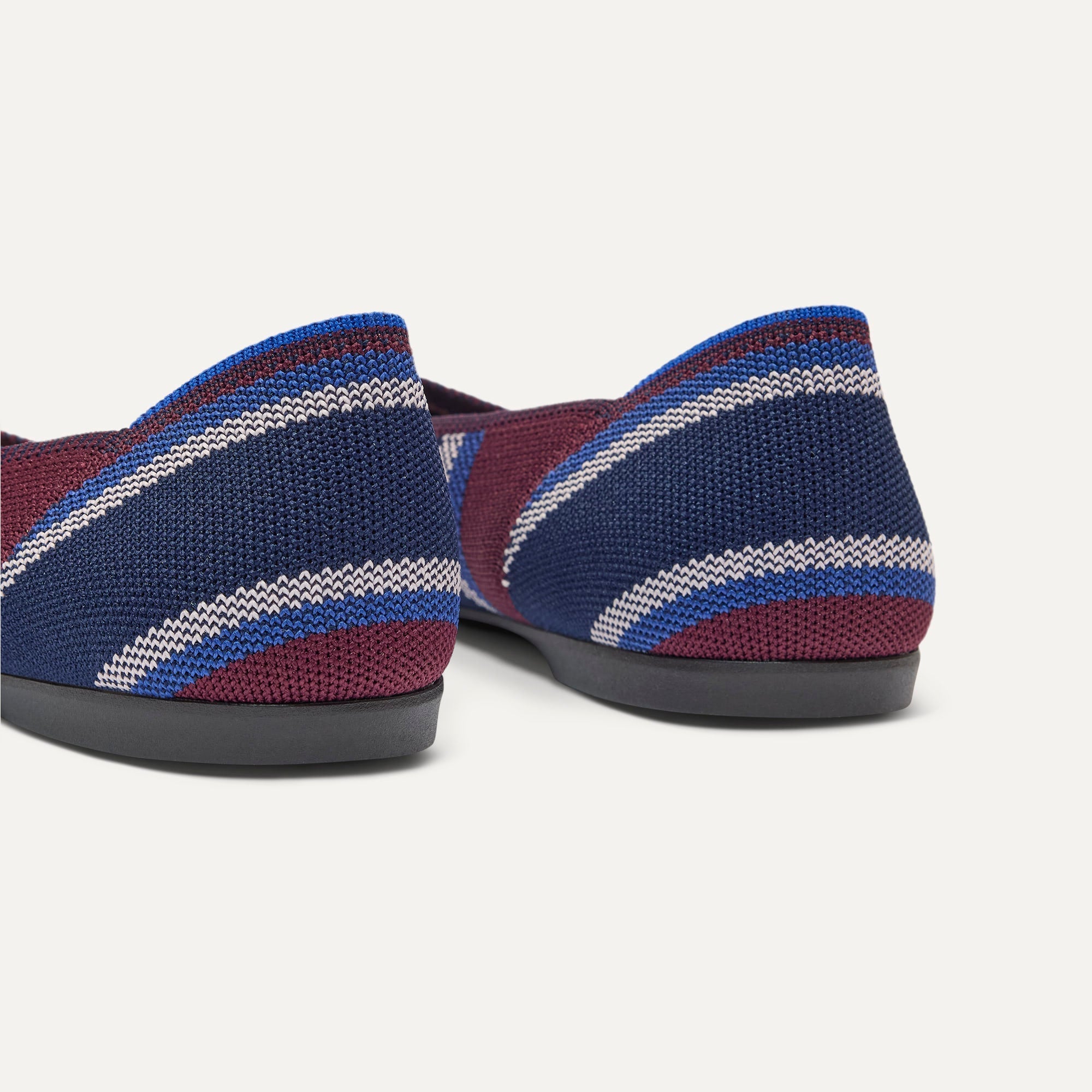 Close up of the heel of The Daily Flat in Fig Stripe, with Rothy's signature blue halo. 