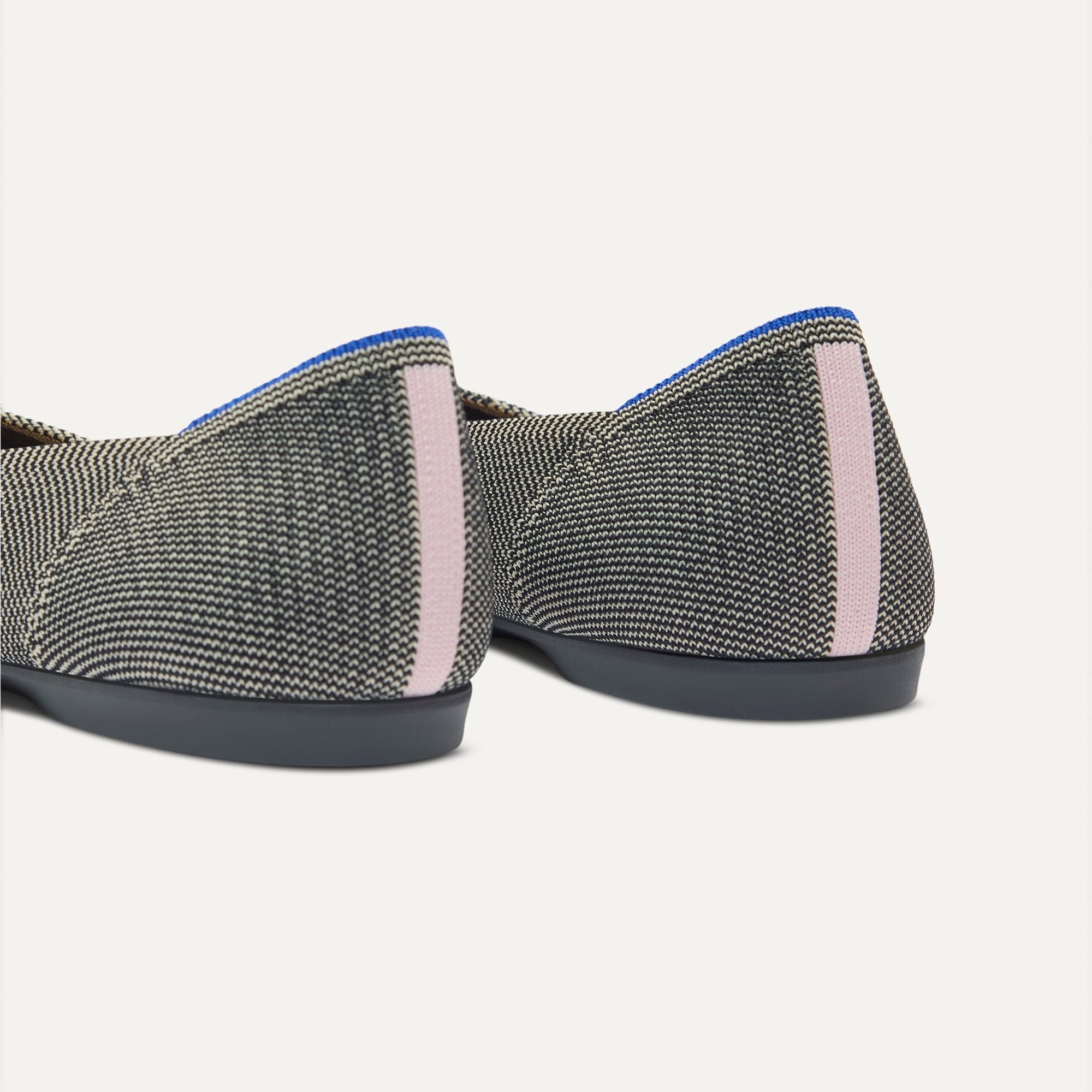 Close up of the heel of The Daily Flat in Salt Air, with Rothy's signature blue halo. 