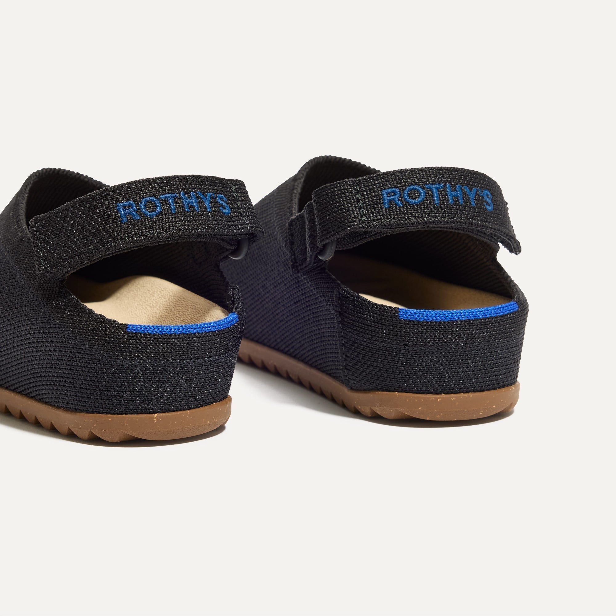 Close up of the heel of The Kids Clog in Black, with Rothy's signature blue halo. 