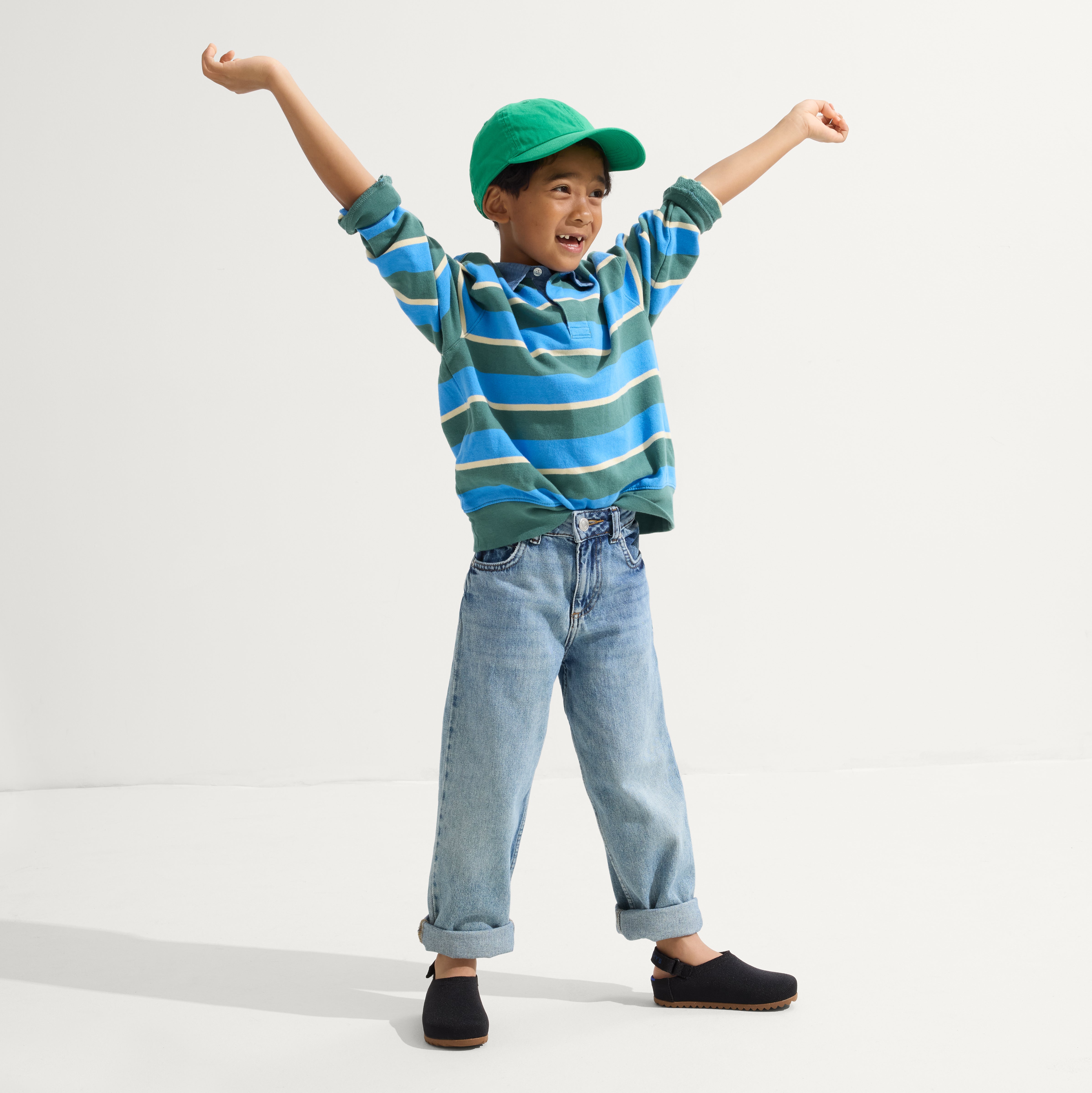 model | Alternate view of a boy wearing The Kids Clog in Black. 