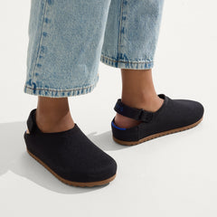 hover | A child wearing The Kids Clog in Black. 