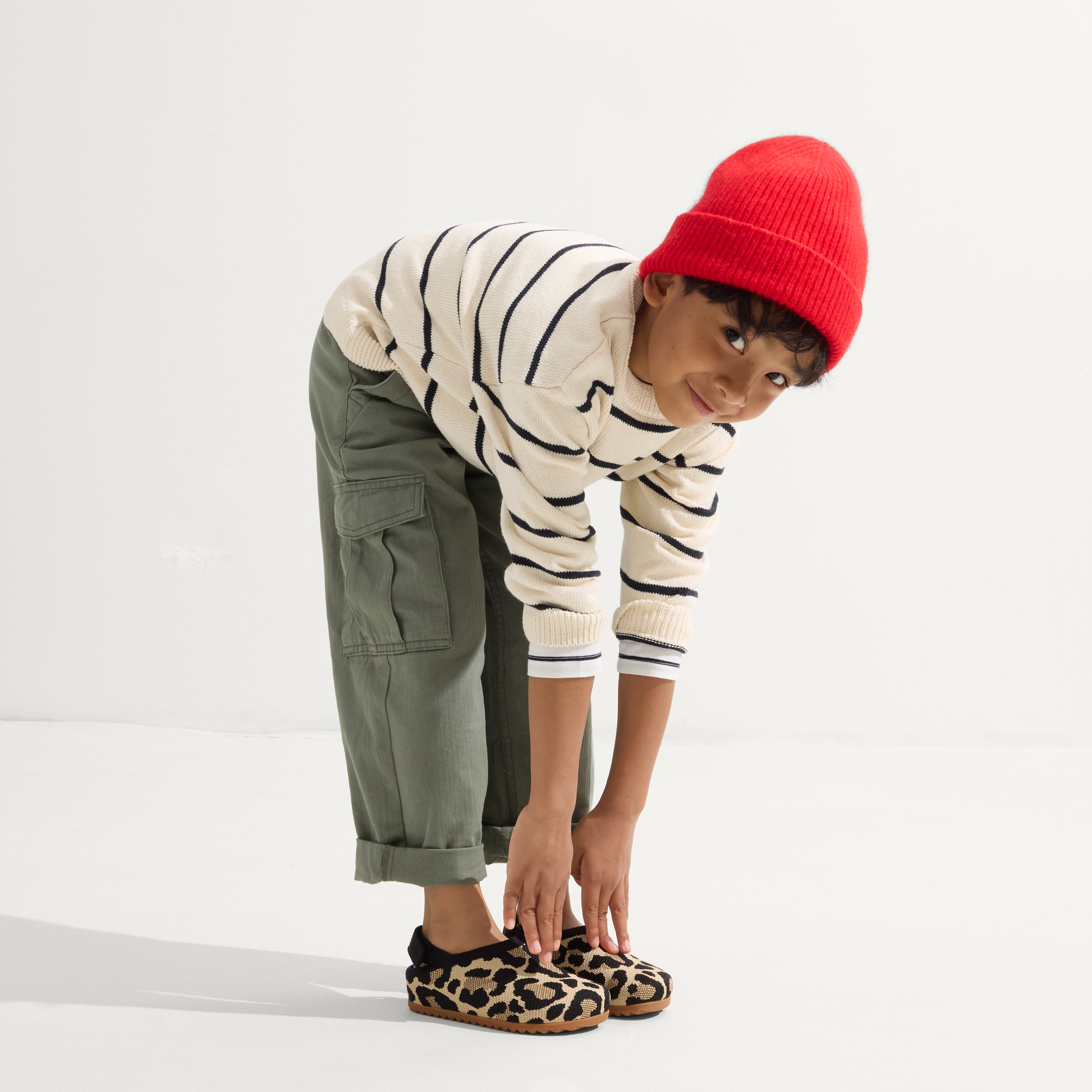model | Alternate view of a child wearing The Kids Clog in Desert Cat. 