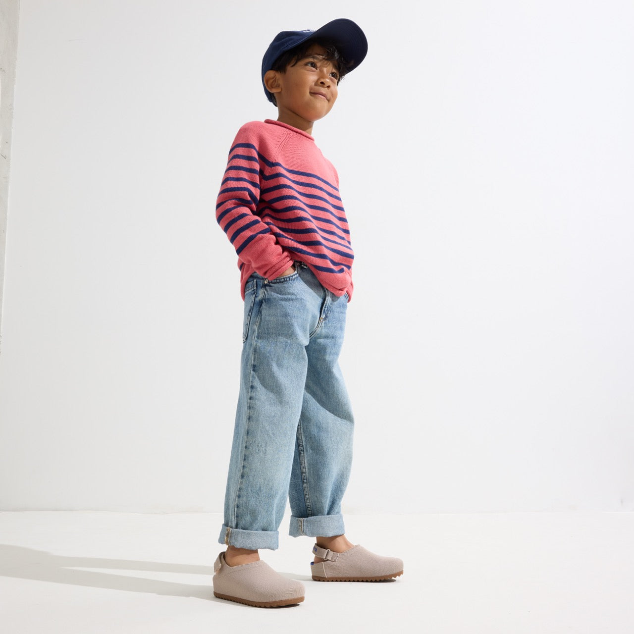 model | Alternate view of a child wearing The Kids Clog in Dove. 