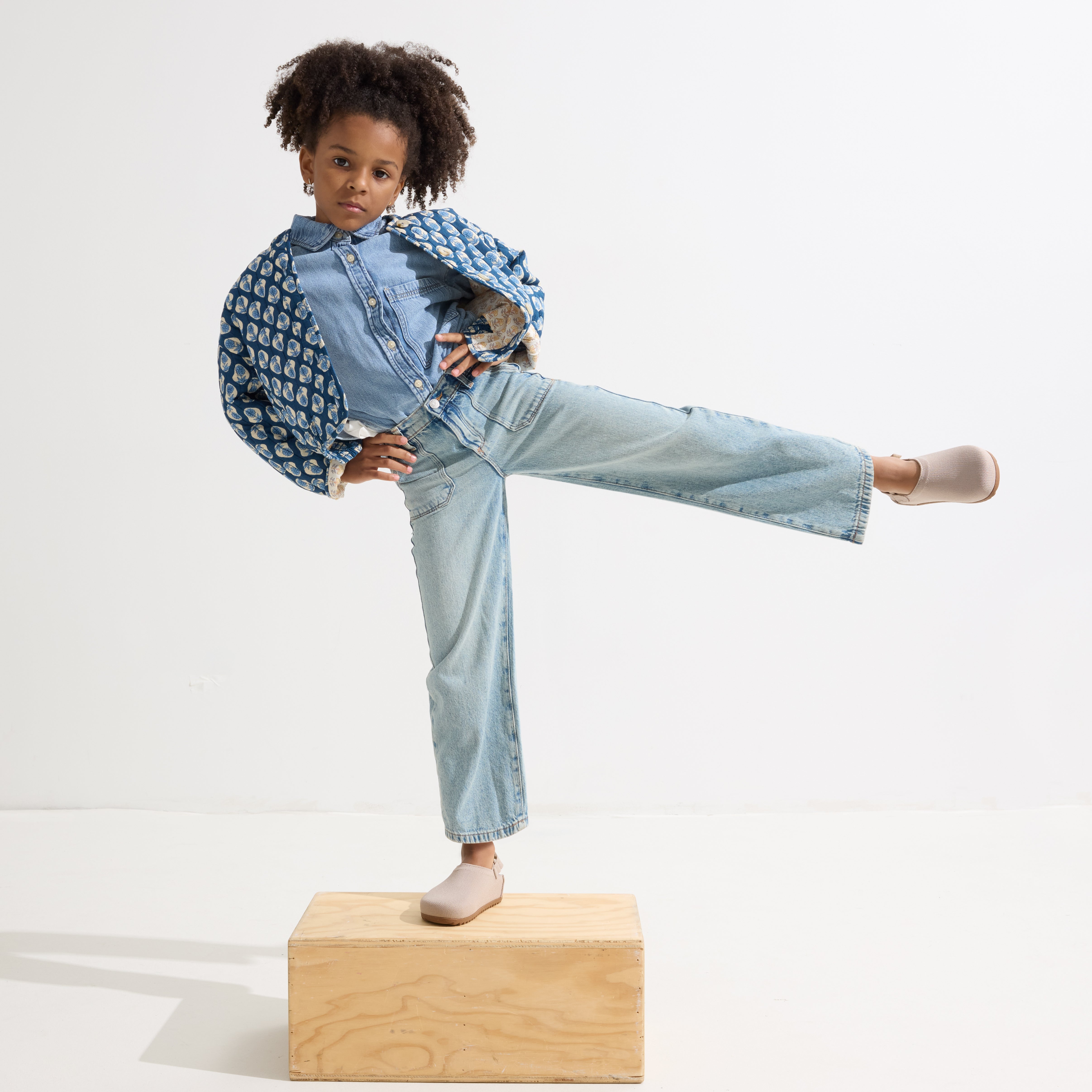 model | Alternate view of a child wearing The Kids Clog in Dove. 