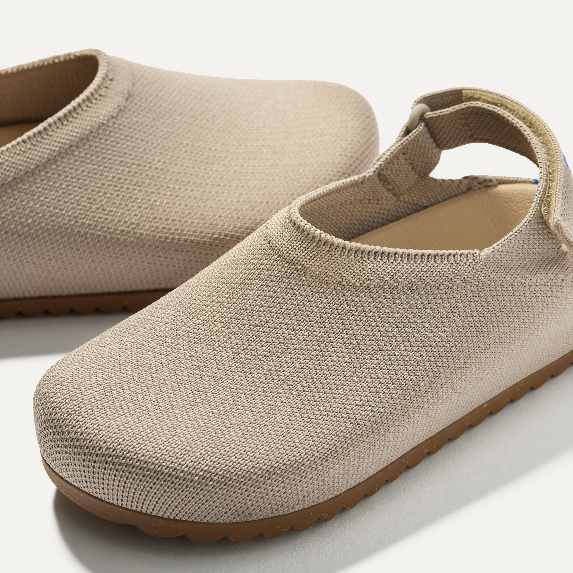 Close up of the rounded topline of The Kids Clog in Dove. 