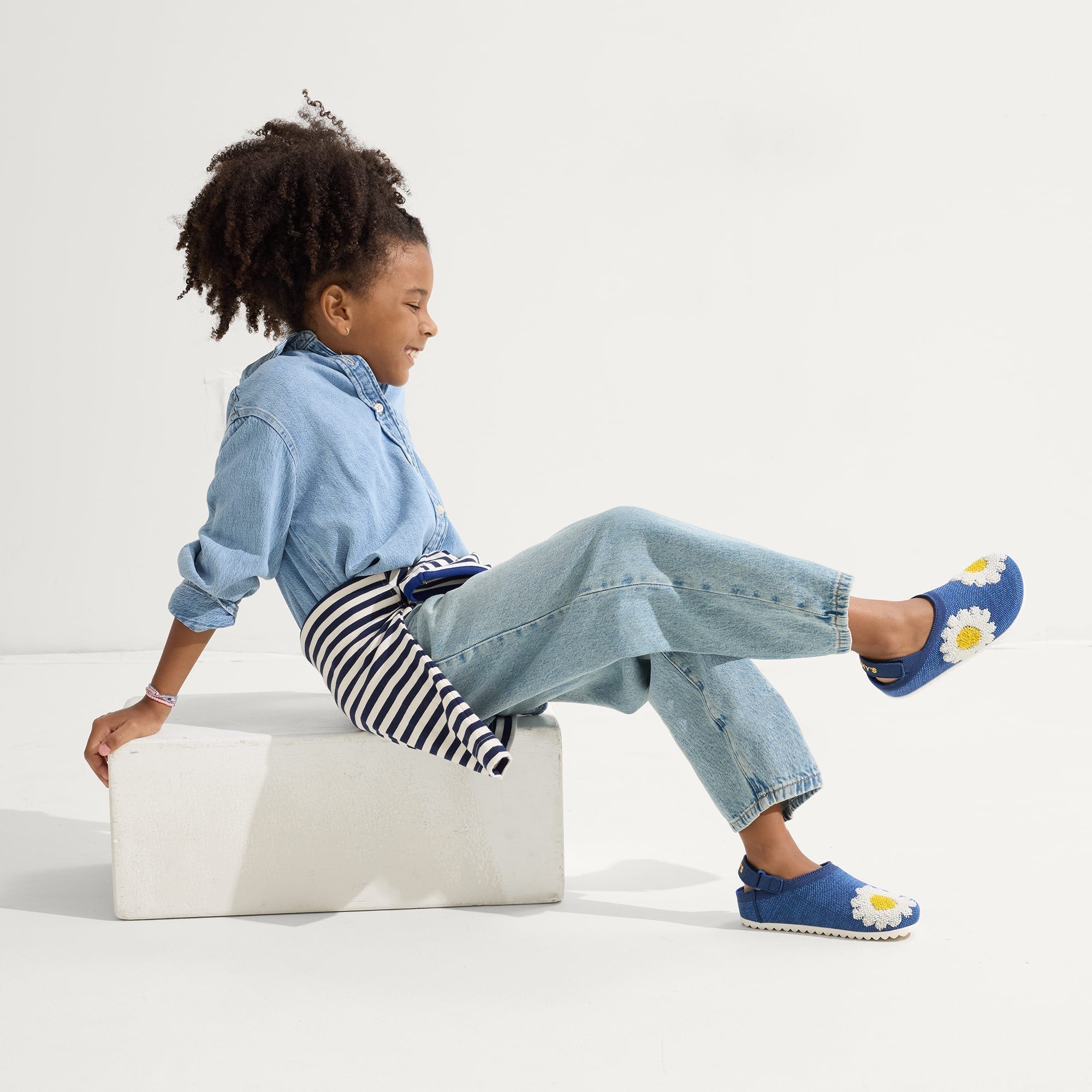 model | Alternate view of a child wearing The Kids Clog in Indigo Daisy. 