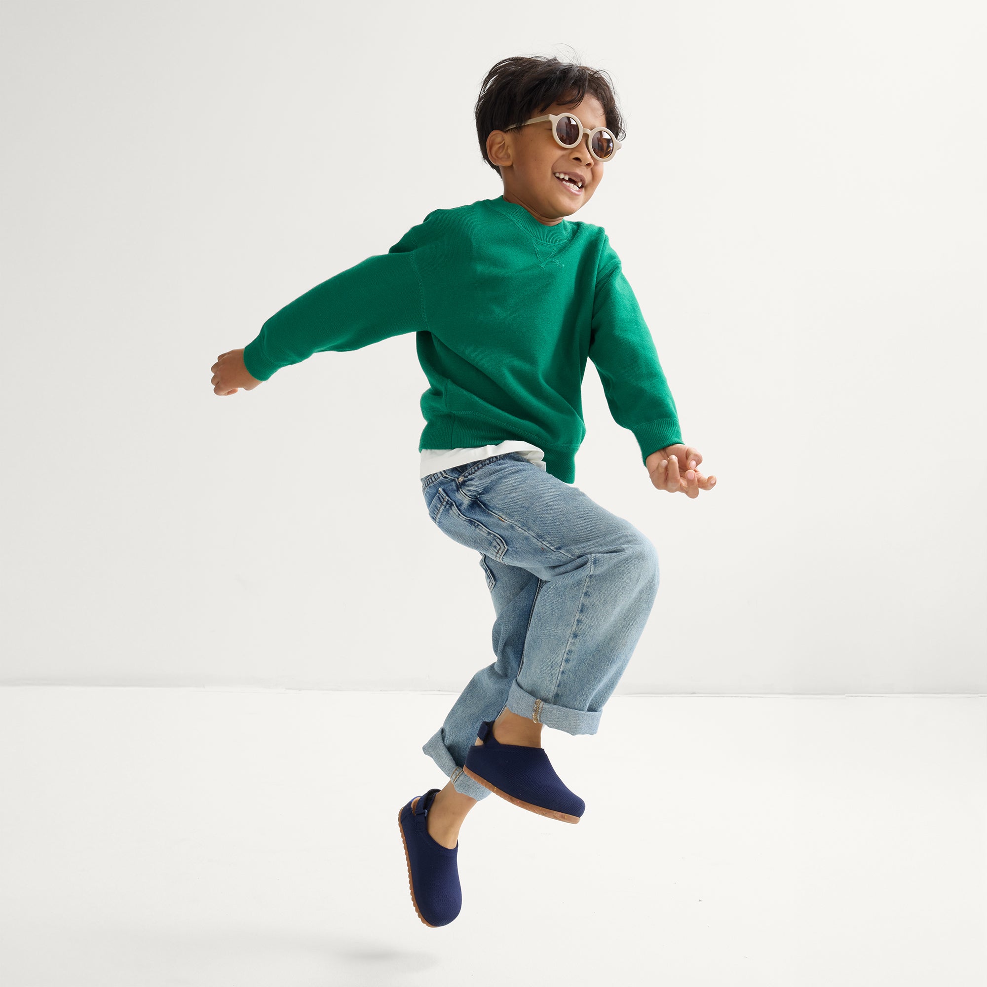 model | An alternate image of a model wearing The Kids Clog in Deep Navy. 