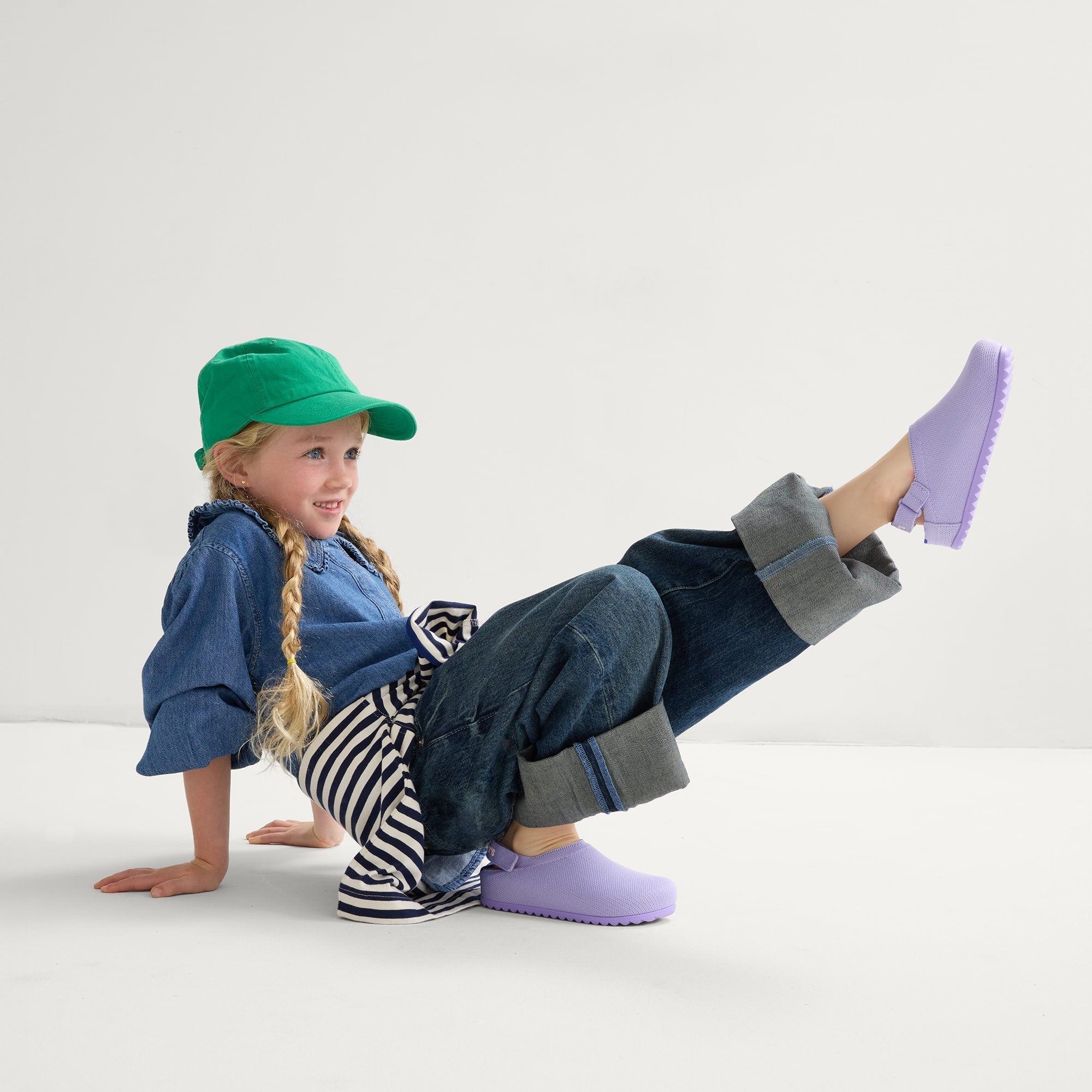 model | Alternate view of a child wearing The Kids Clog in Soft Orchid. 