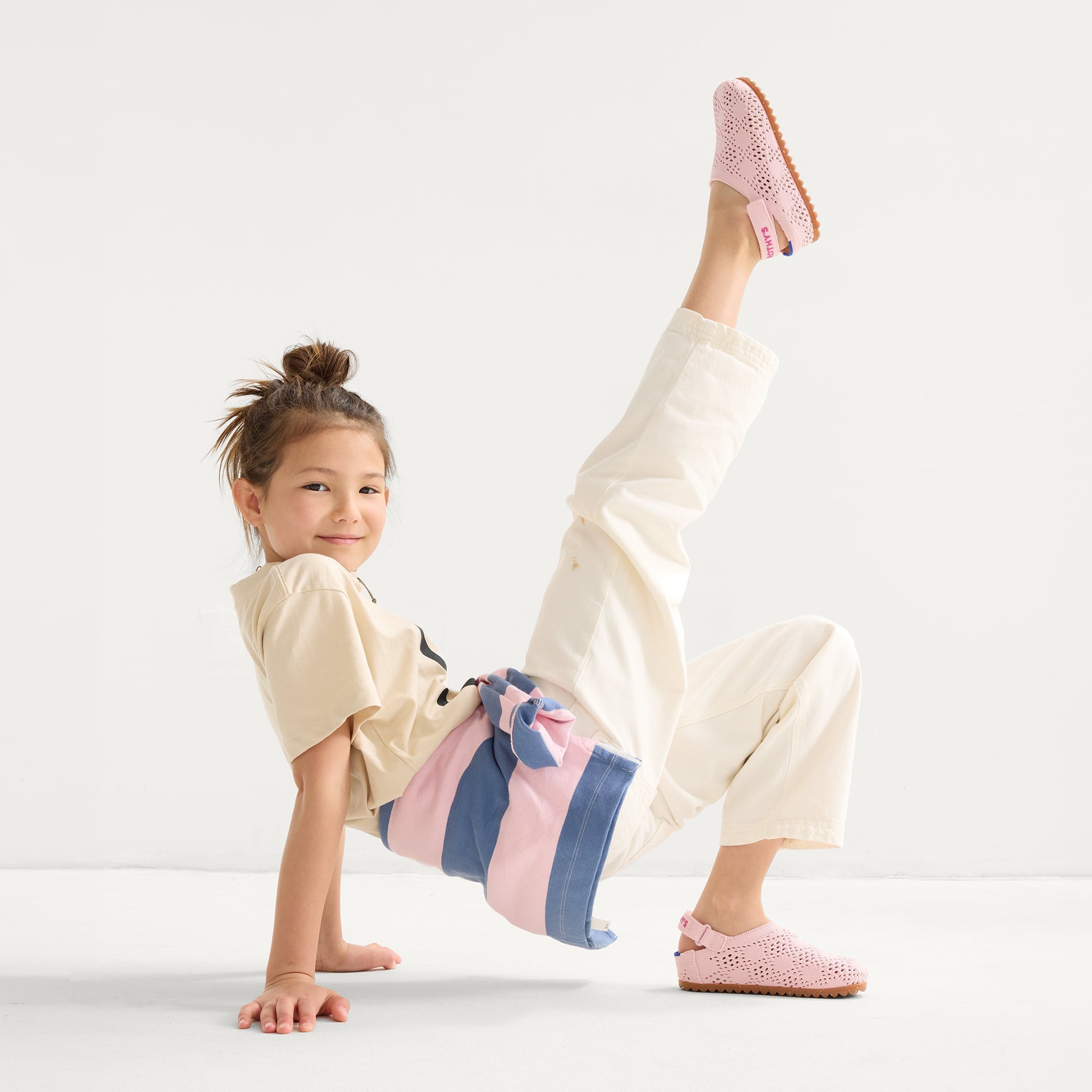 model | Alternate view of a child wearing The Kids Clog in Pink Crochet. 