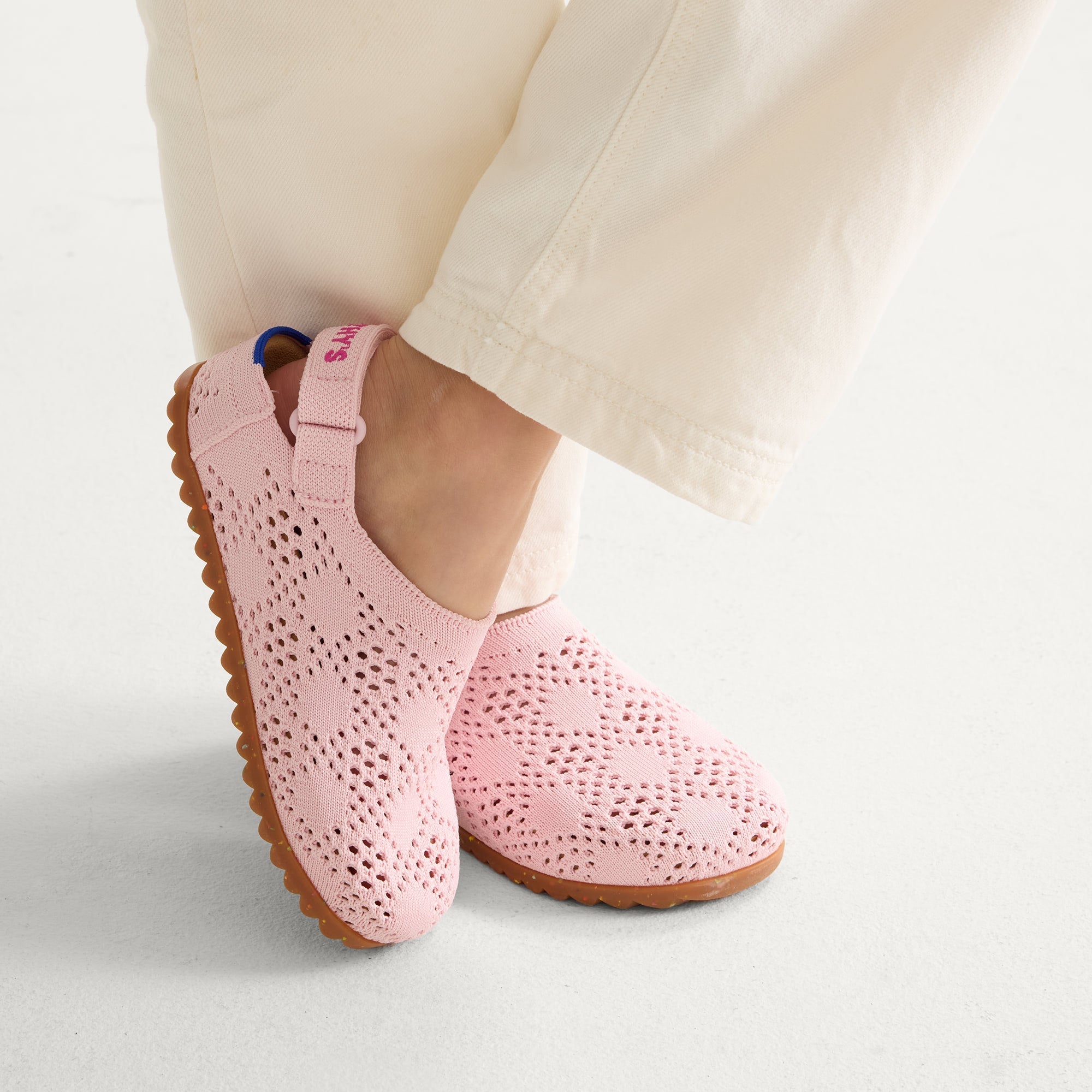 hover | A child wearing The Kids Clog in Pink Crochet. 