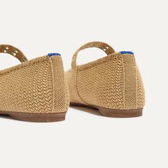 Close up of the heel of The Max Buckle Mary Jane in Tan Woven, with Rothy's signature blue halo.