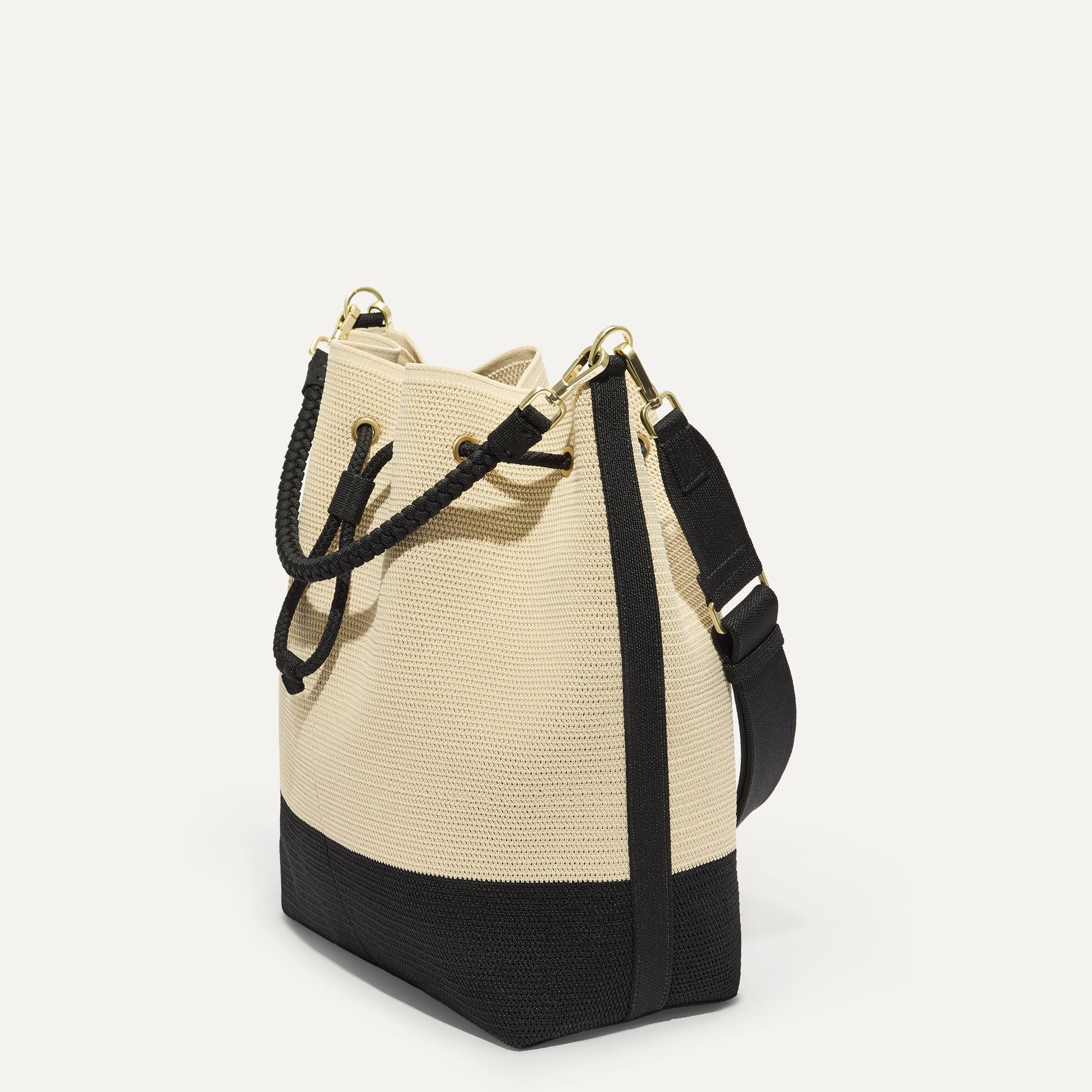 The Cinch Bucket Bag in Black and White Raffia-Knit shown from the side.