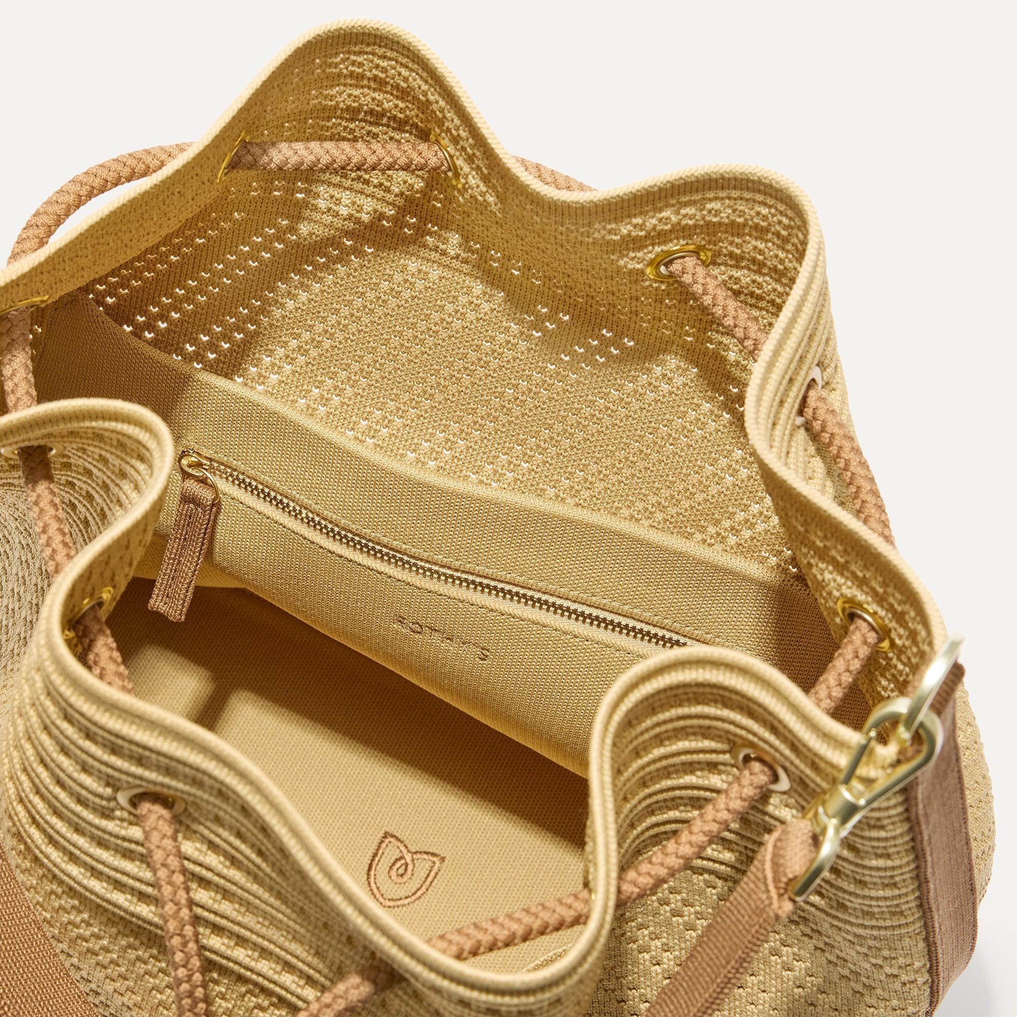 A close up of The Cinch Bucket Bag in Brown Butter Crochet showing the interior pockets.