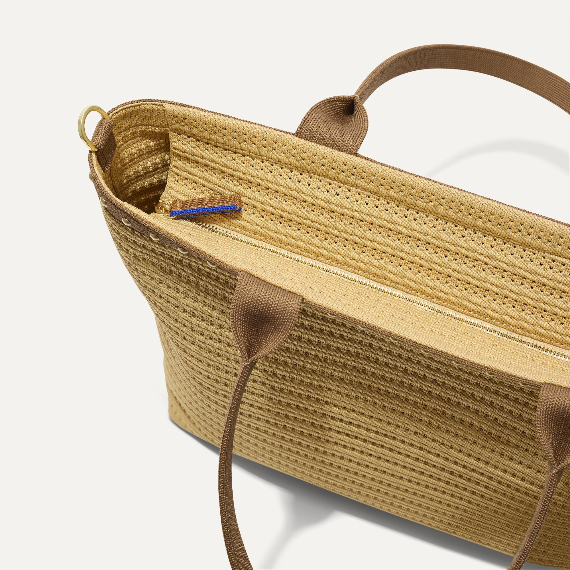 The Lightweight Zip Tote in Brown Butter Crochet, focusing on the zip closure and handles